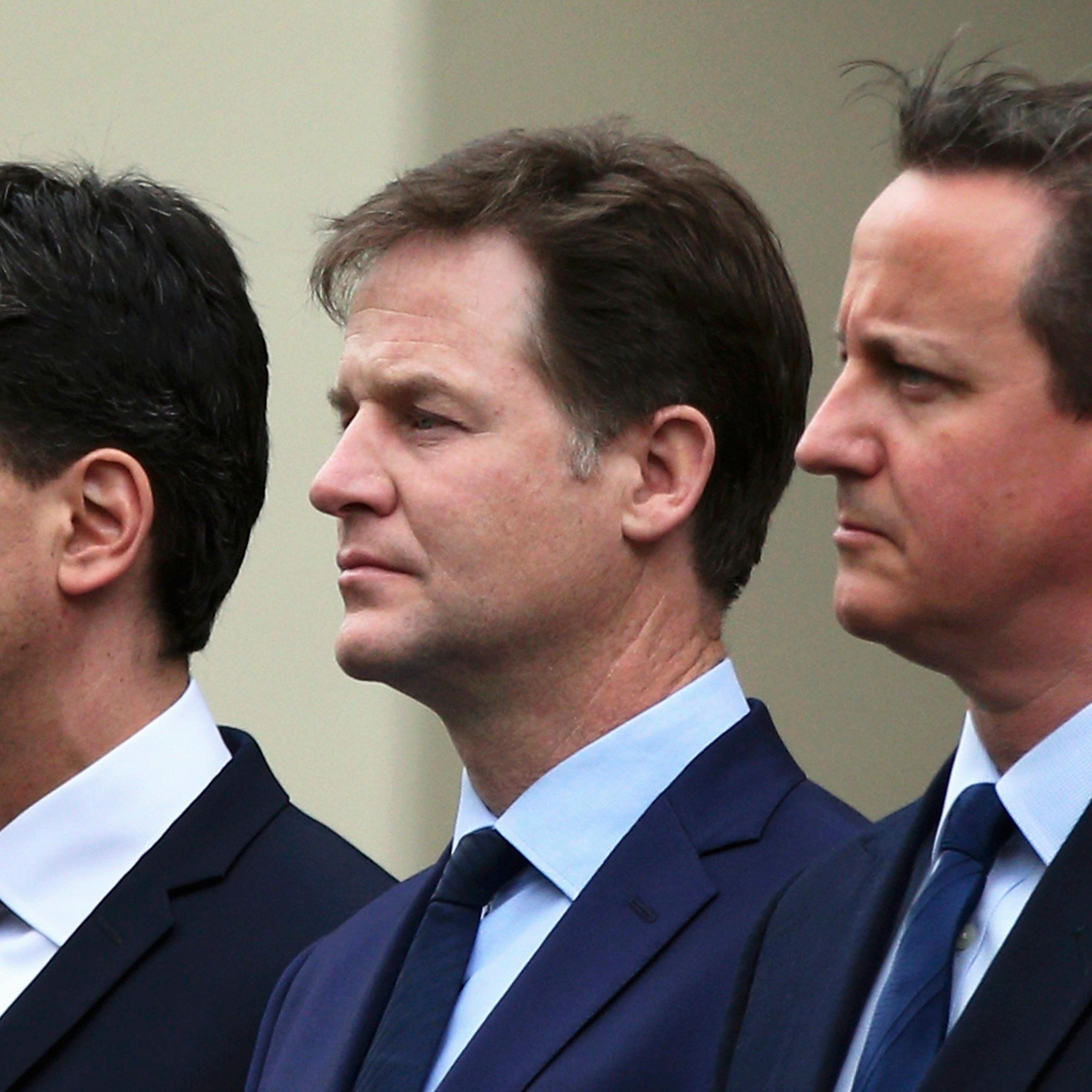 Britain's Prime Minister David Cameron (R) stands with former former Liberal Democrat leader Nick Clegg (C) and former Labour Party leader Ed Miliband, as they line up to pay tribute at the Cenotaph during a Victory in Europe (VE) day ceremony in central