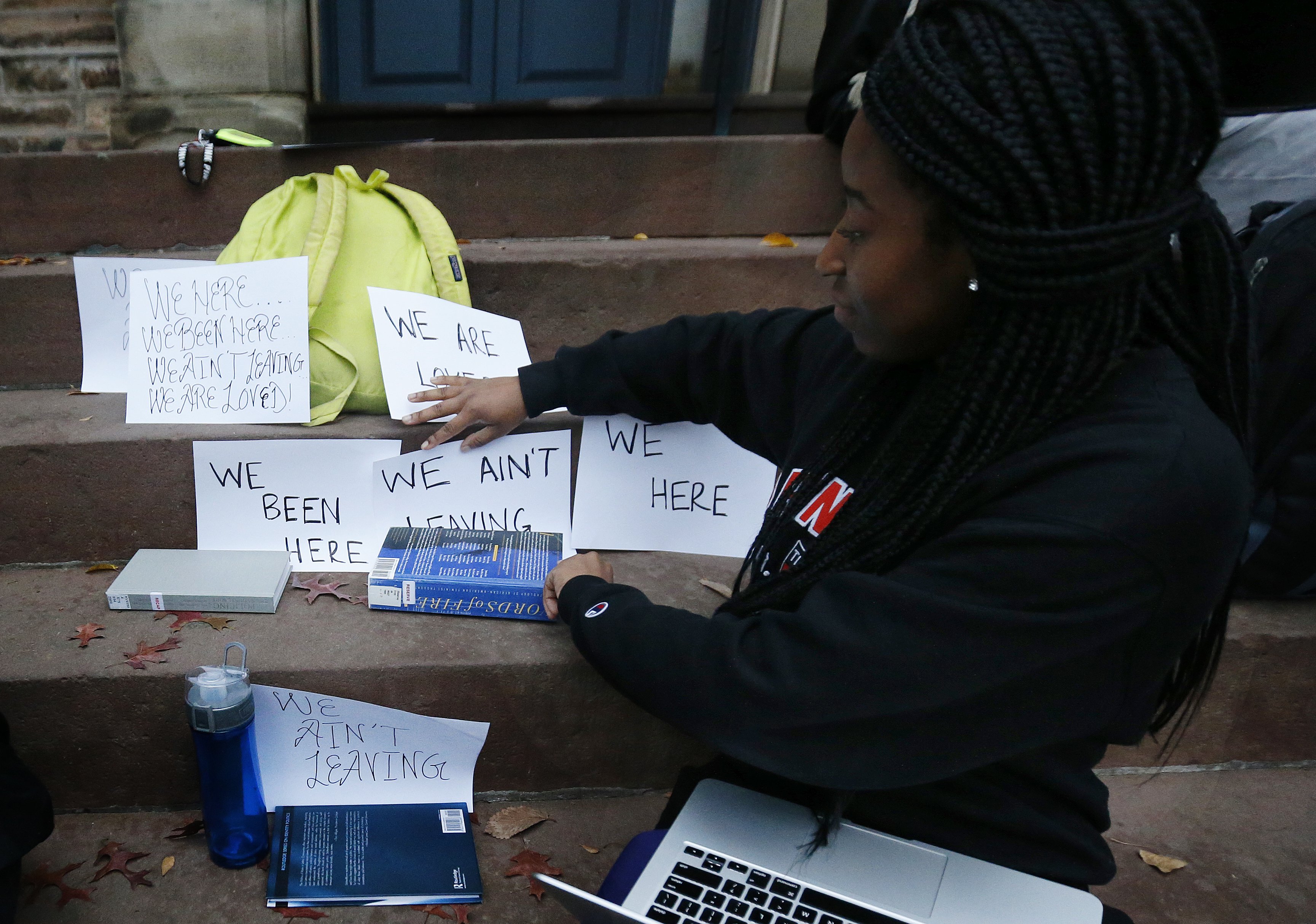 A student shows signs made for a sit-in to demand changes to improve the social and academic experience of black students, at Princeton University in Princeton, N.J. on Nov. 18, 2015.