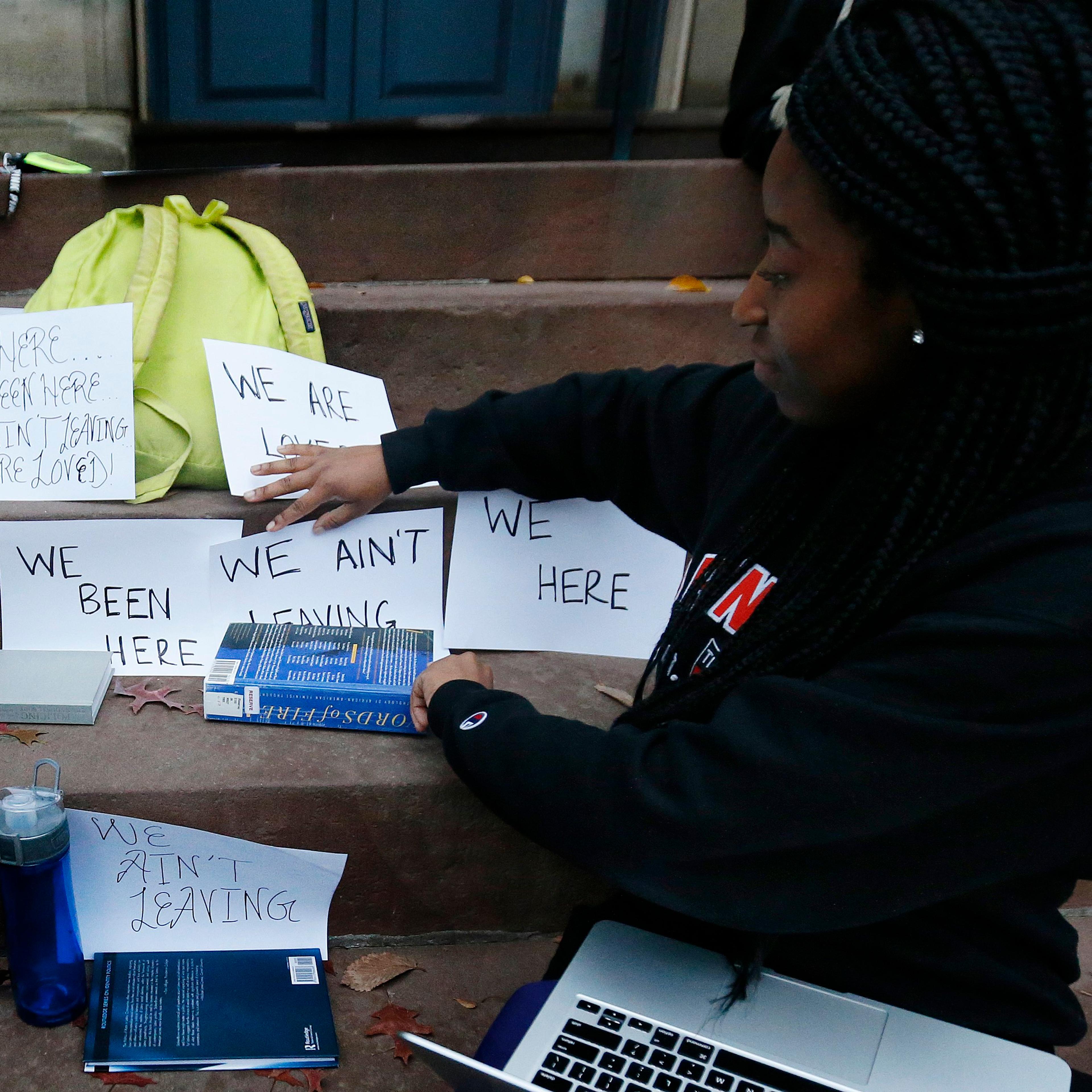 A student shows signs made for a sit-in to demand changes to improve the social and academic experience of black students, at Princeton University in Princeton, N.J. on Nov. 18, 2015.