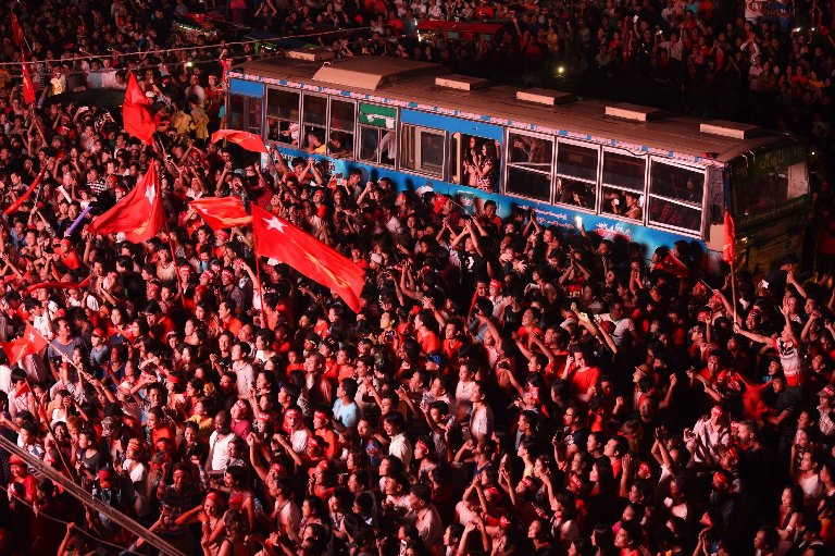 Supporters of Aung San Suu Kyi's National League for Democracy party cheer as they watch results from Myanmar's election, Nov. 9, 2015.