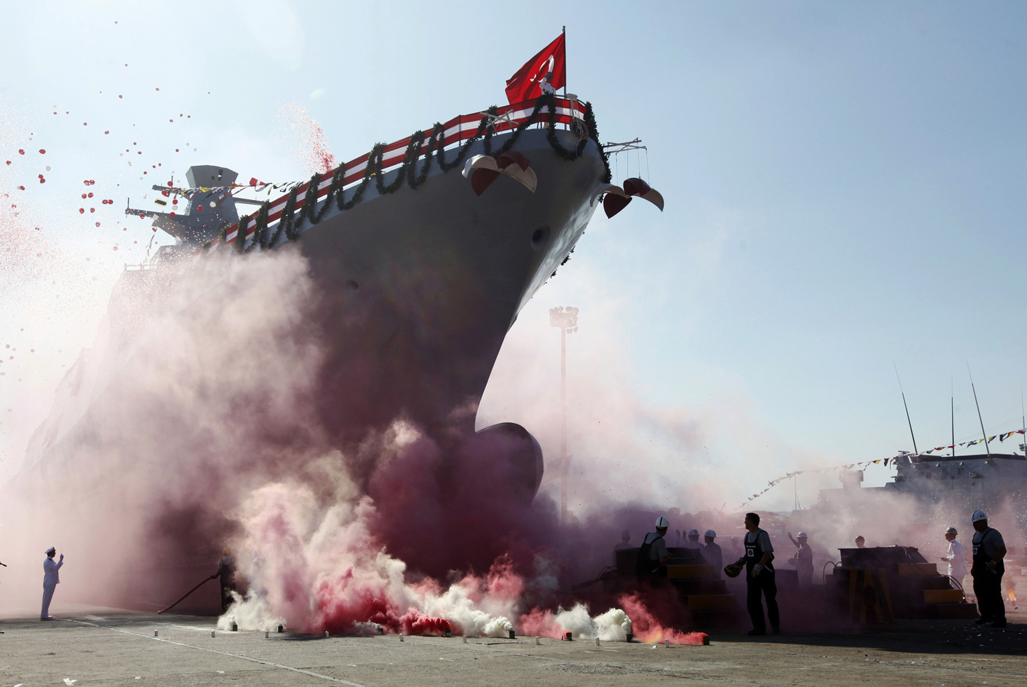 September 27, 2011. Workers and officers attend the launch for the second nationally designed combat ship TCSG Buyukada, at the Tuzla Naval shipyard in Istanbul. 