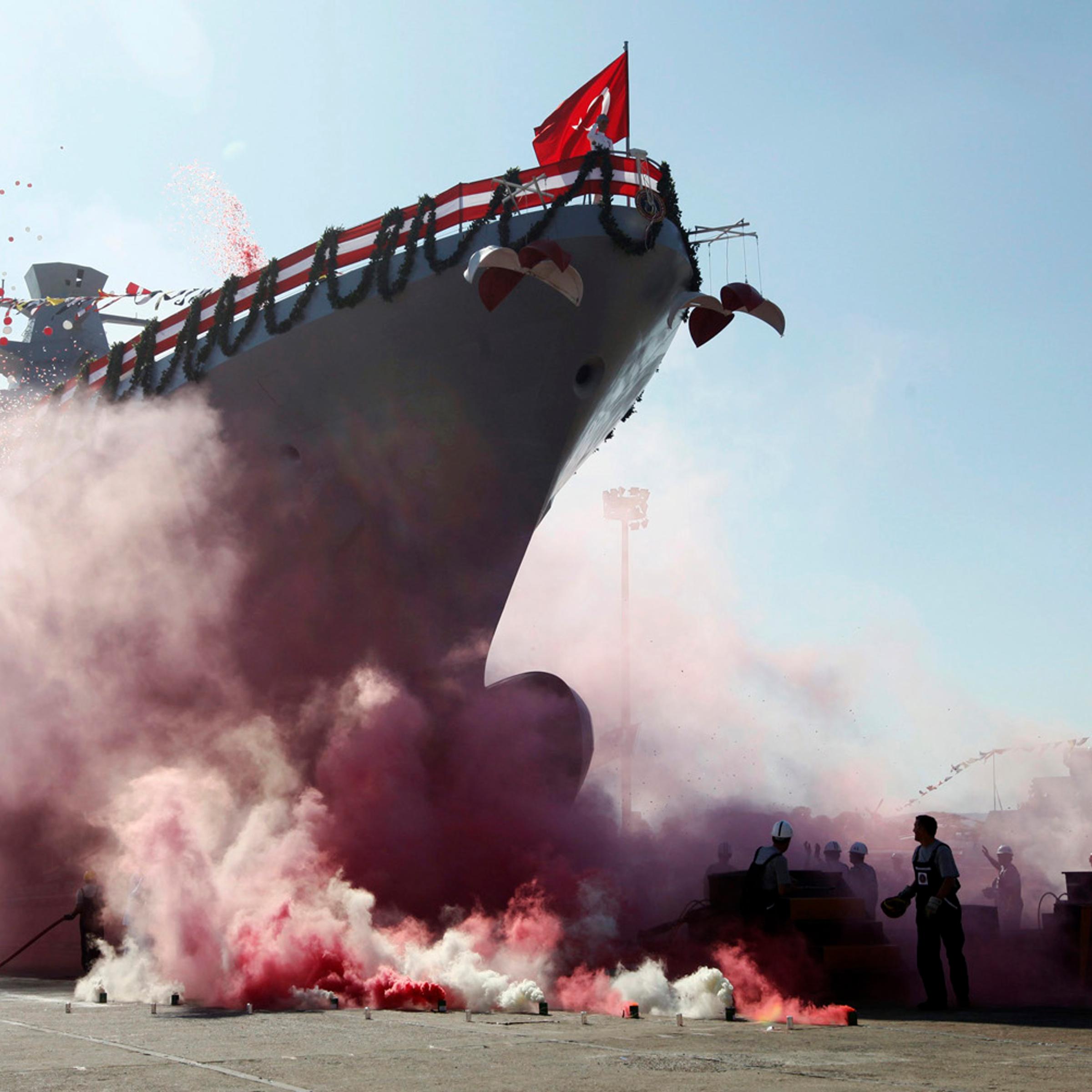 September 27, 2011. Workers and officers attend the launch for the second nationally designed combat ship TCSG Buyukada, at the Tuzla Naval shipyard in Istanbul.