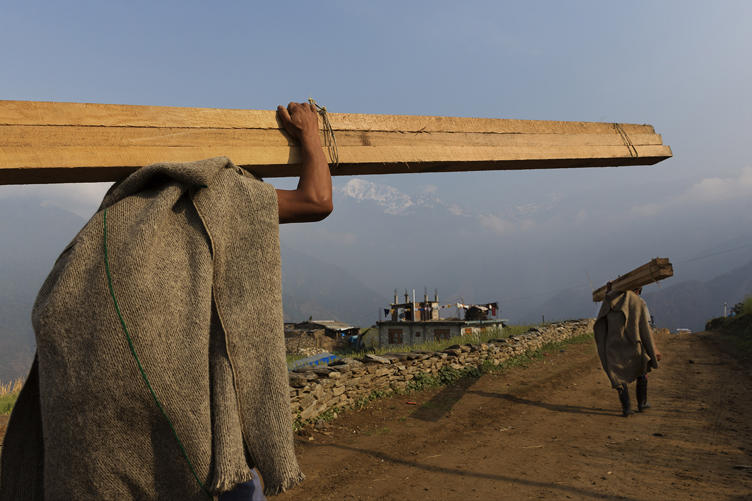 Following the 2015 earthquakes in Nepal more than 600,000 homes were destroyed, Damage from the quakes is estimated at around $7 billion. Nearly one year later, villagers rebuild houses and pathways in the village of Barpak at the quake's epicenter, Apri