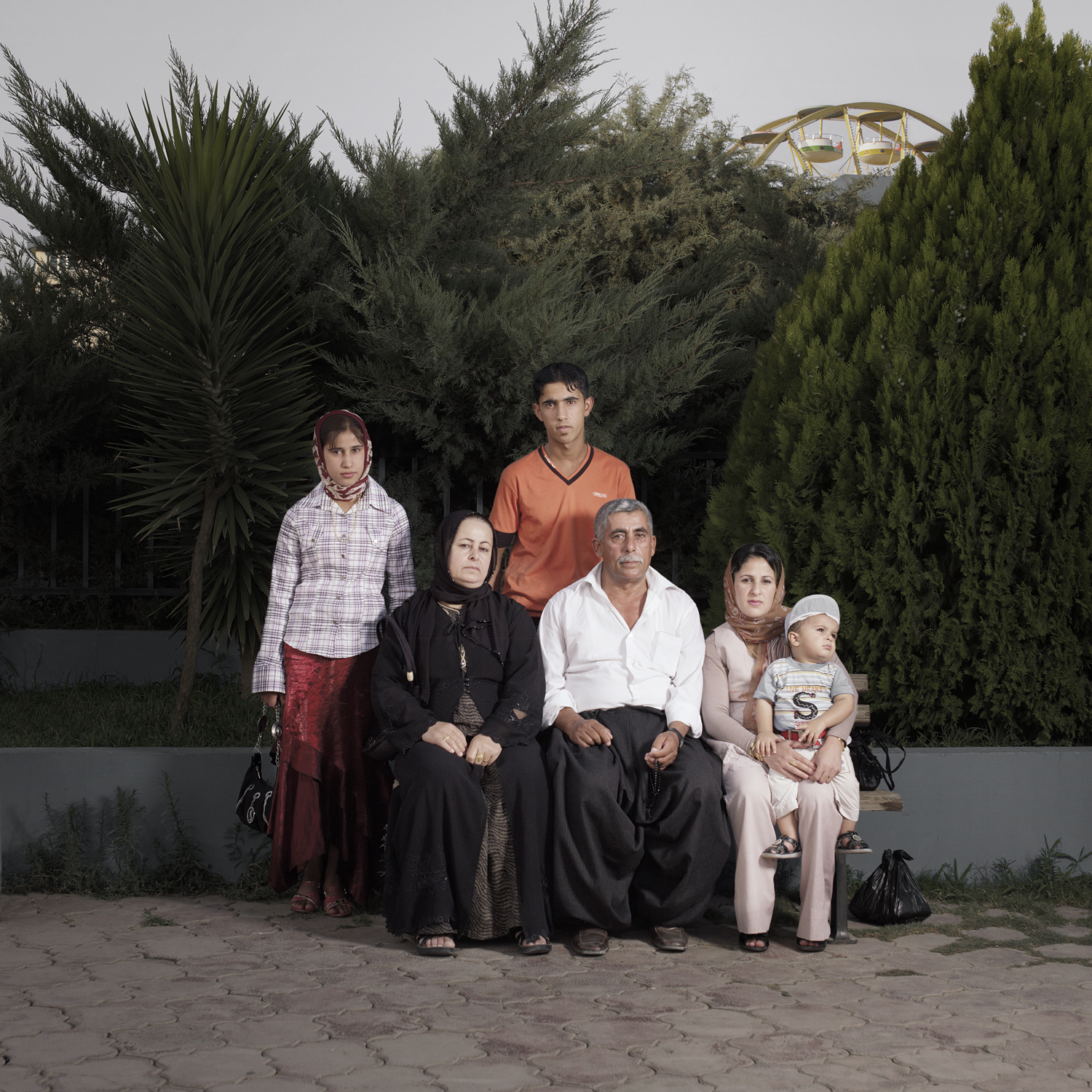 <strong>Mohammad &amp; Gulbagh, their children and grandson, Dream City, Iraq</strong>
<br>
<br>
"While Iraq is in a state of war, the north of the country—Kurdistan—is relatively stable. Since the no-fly zone was established after the First Gulf War in 1991, the autonomous region of Kurdistan has been a de facto independent state. The Kurdish security forces, the Peshmergas, 'those who face death', have built bunkers and lookout posts to keep terrorism out. This makes it an attractive holiday destination for the Arab Iraqis and American soldiers." 