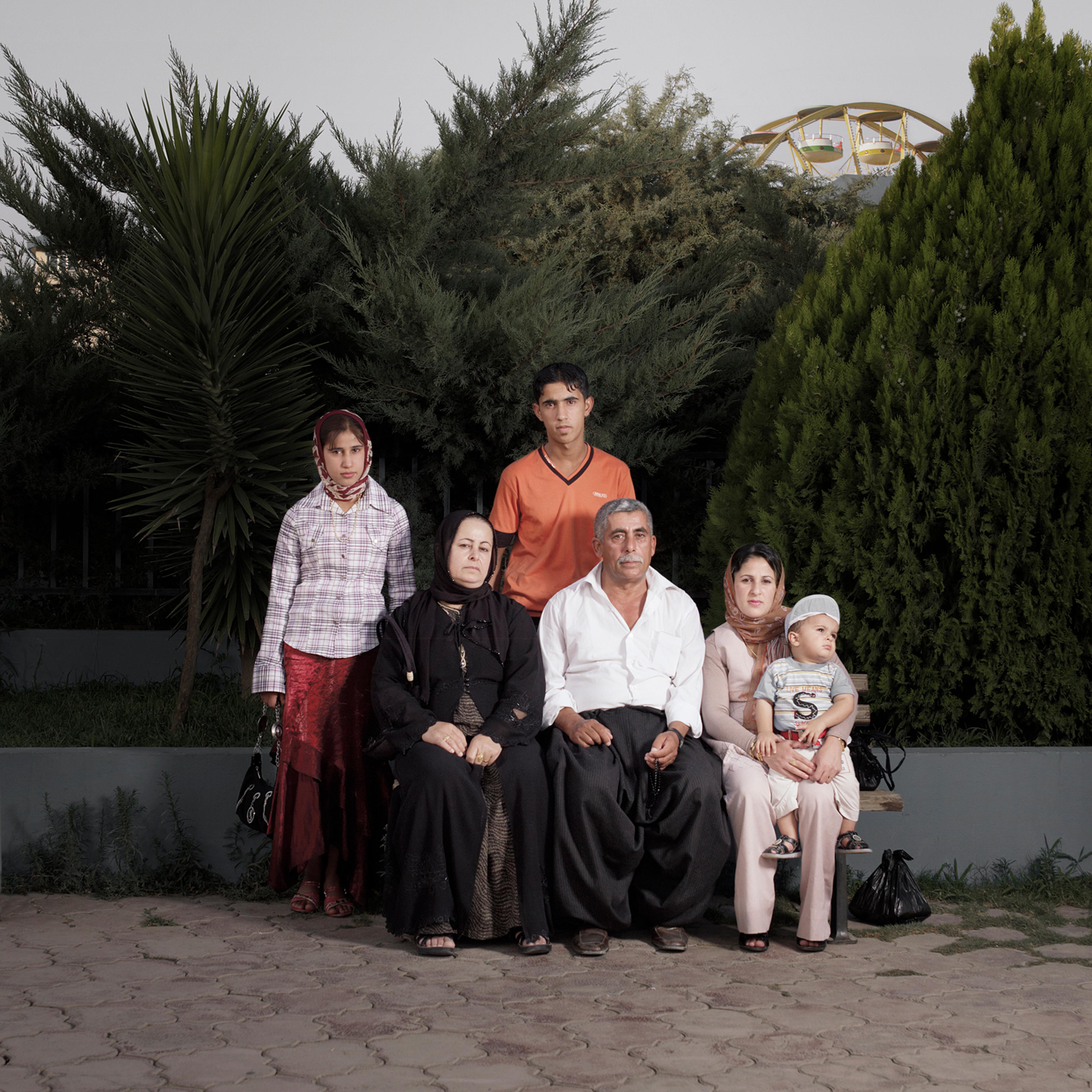 <strong>Mohammad & Gulbagh, their children and grandson, Dream City, Iraq</strong>
<br>
<br>
"While Iraq is in a state of war, the north of the country—Kurdistan—is relatively stable. Since the no-fly zone was established after the First Gulf War in 1991, the autonomous region of Kurdistan has been a de facto independent state. The Kurdish security forces, the Peshmergas, 'those who face death', have built bunkers and lookout posts to keep terrorism out. This makes it an attractive holiday destination for the Arab Iraqis and American soldiers."