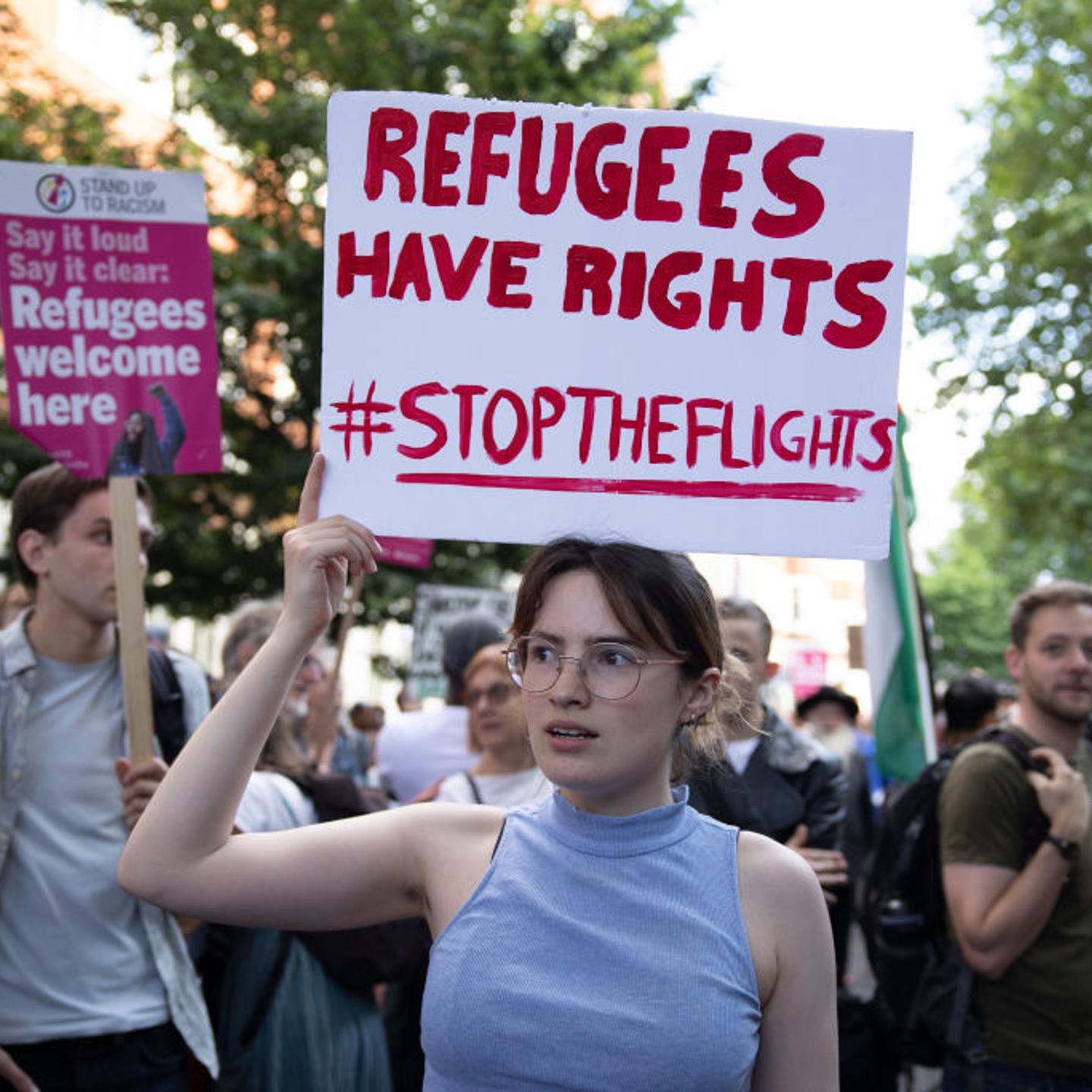 A protester holds a placard expressing her opinion during