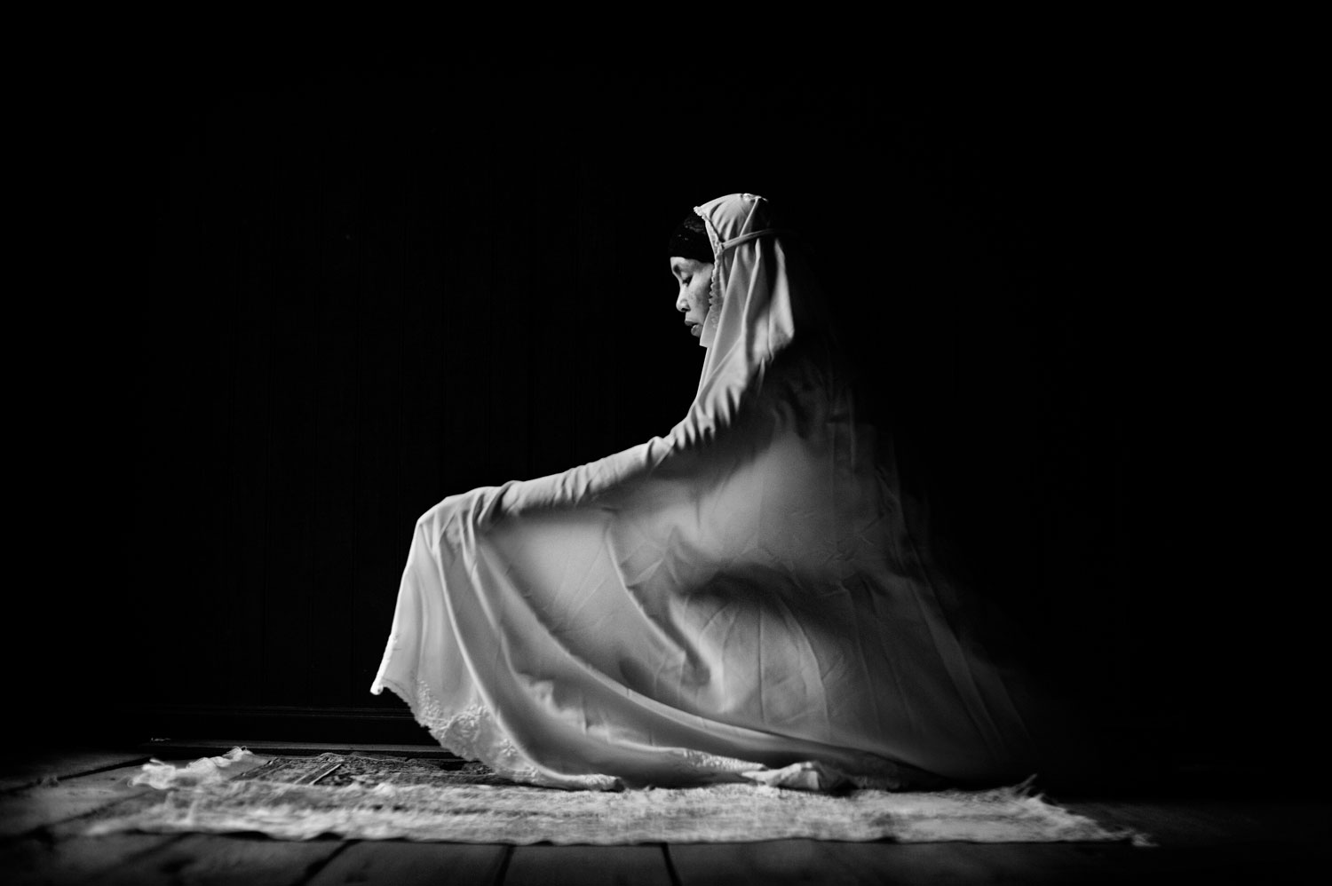 "In my journey through Thailand’s troubled deep south, providence took me to Narathiwat town and finally to the house of the Raja. This once magnificent residence is now dilapidated, but still holds a haunting power that caught me in its spell as soon as I set foot in it. Its atmosphere of dignified solitude, shrouded in shadow and light, pulled me out from the conflict and bloodshed of the present into a dimension filled with timeless spirituality." 2010<br> 
<i>Caption comments courtesy of Xavier Comas</i>