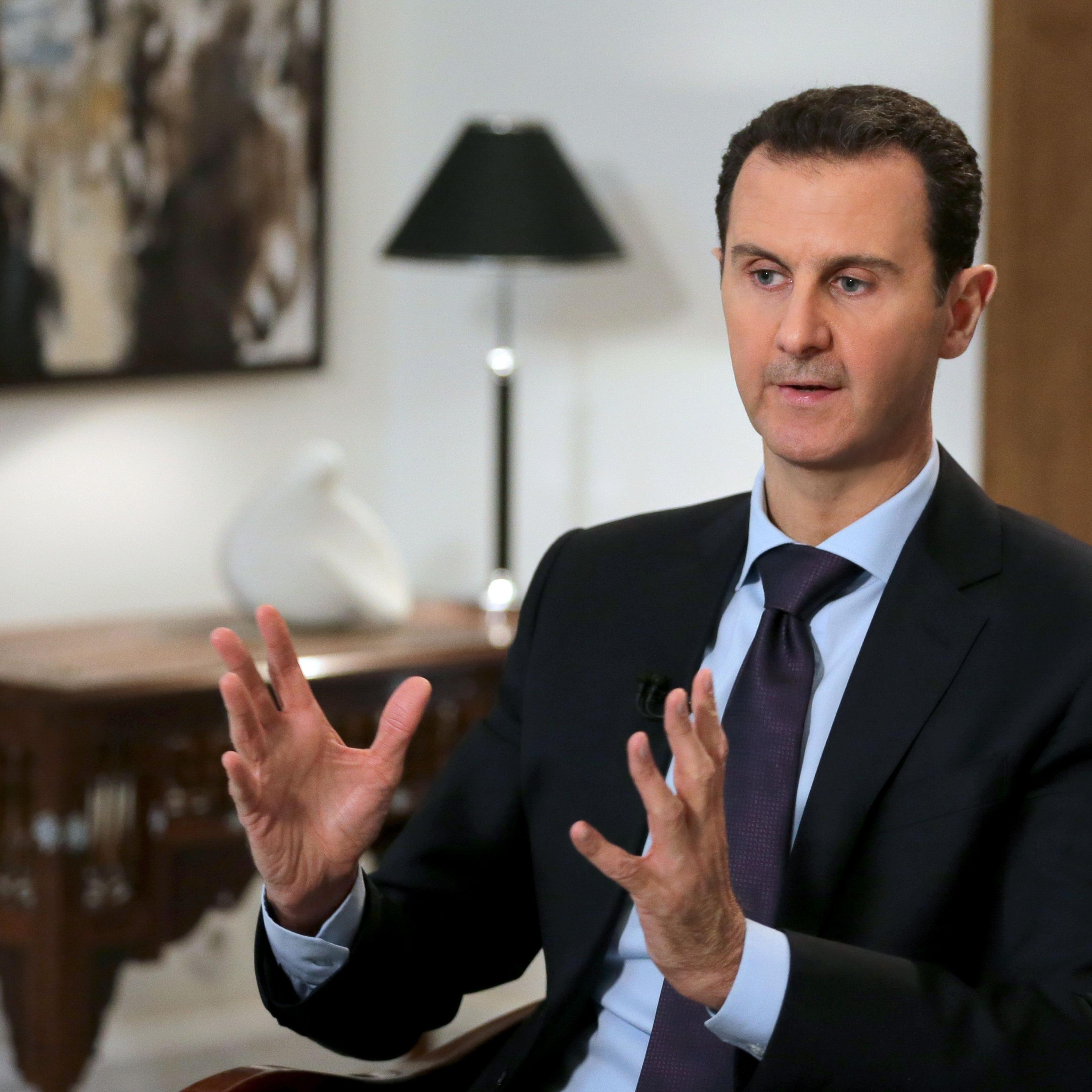 Syrian President Bashar al-Assad gestures during an exclusive interview in the capital Damascus on February 11, 2016.