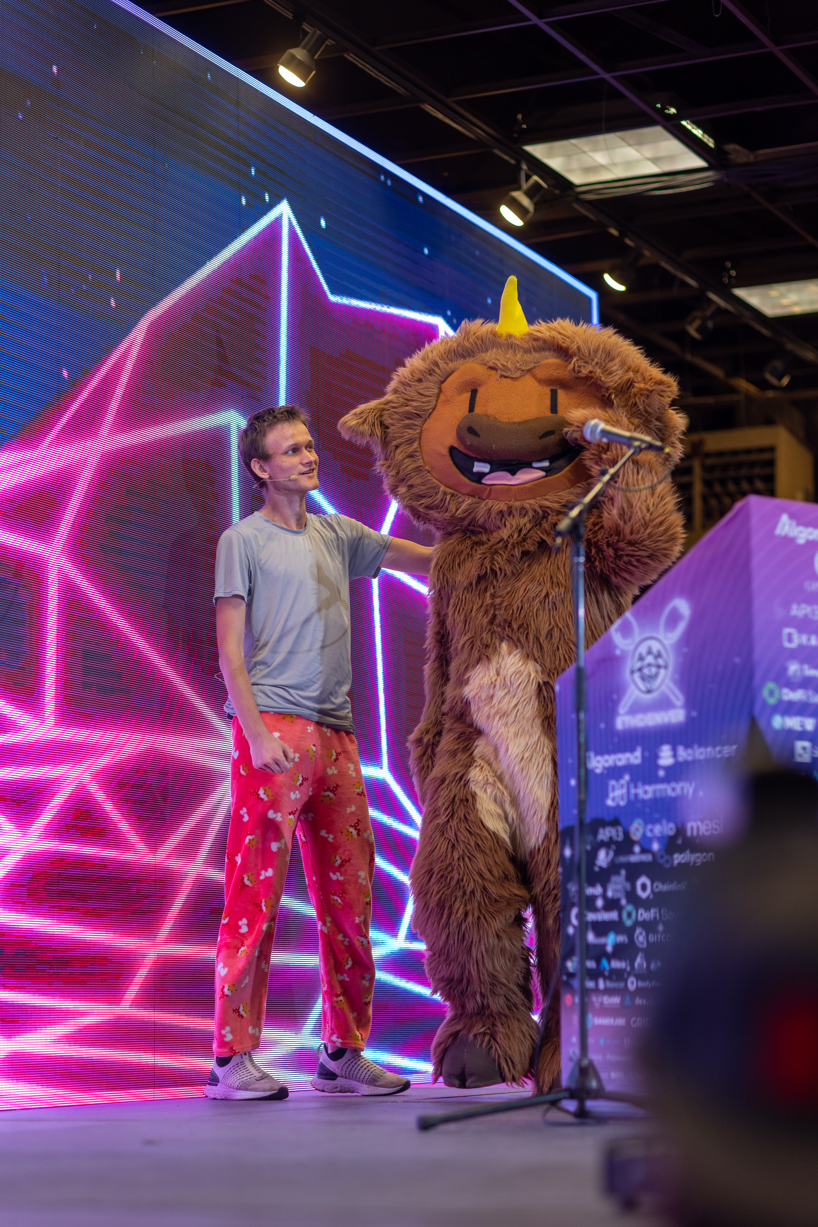 Vitalik Buterin, the founder of Ethereum onstage at ETHDenver next to the conference's mascot, Buffi. 
