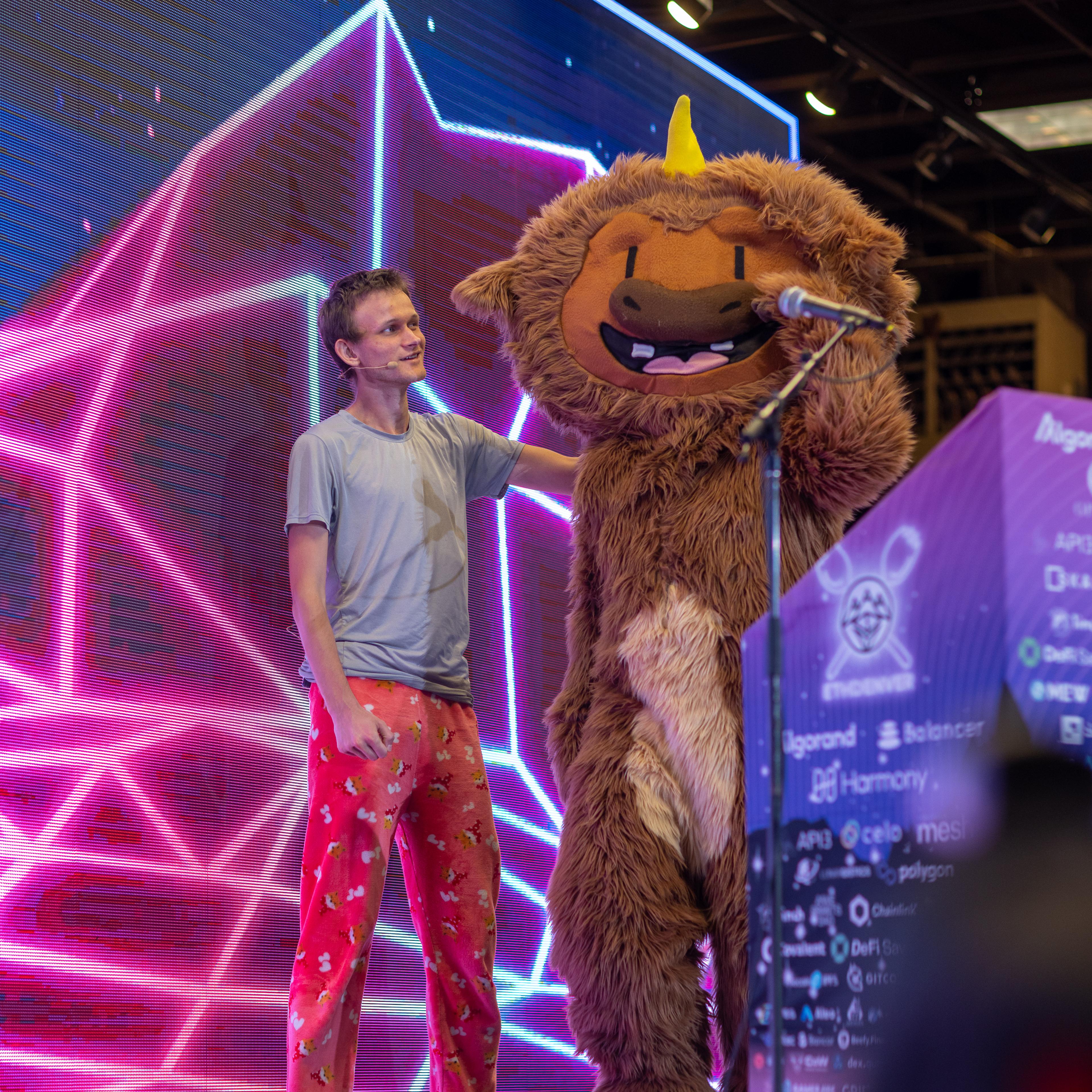 Vitalik Buterin, the founder of Ethereum onstage at ETHDenver next to the conference's mascot, Buffi.