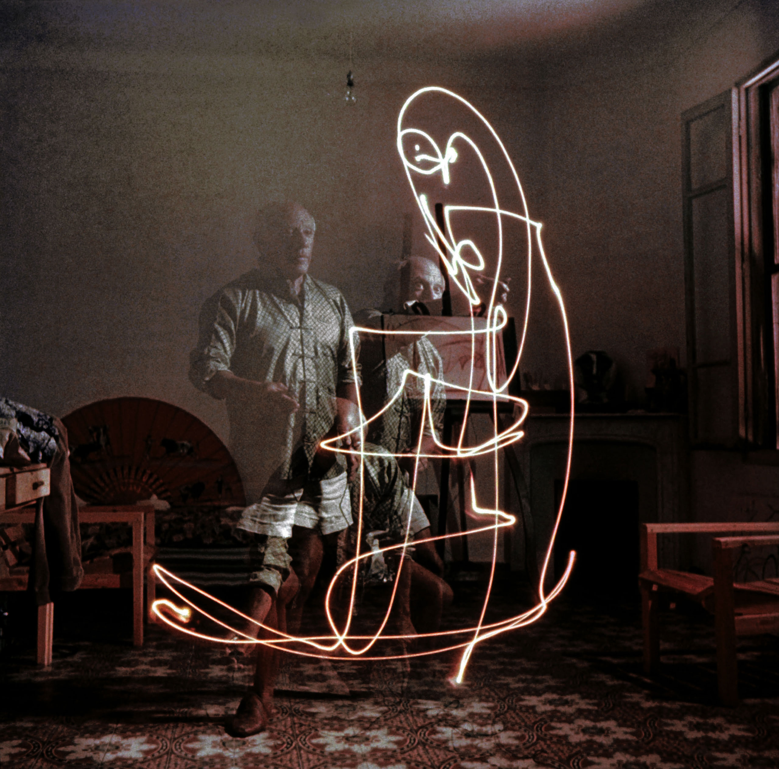 By setting off a 1/10,000-second strobe light, [Mili] caught Picasso's intense, agile figure as it flailed away at the drawings