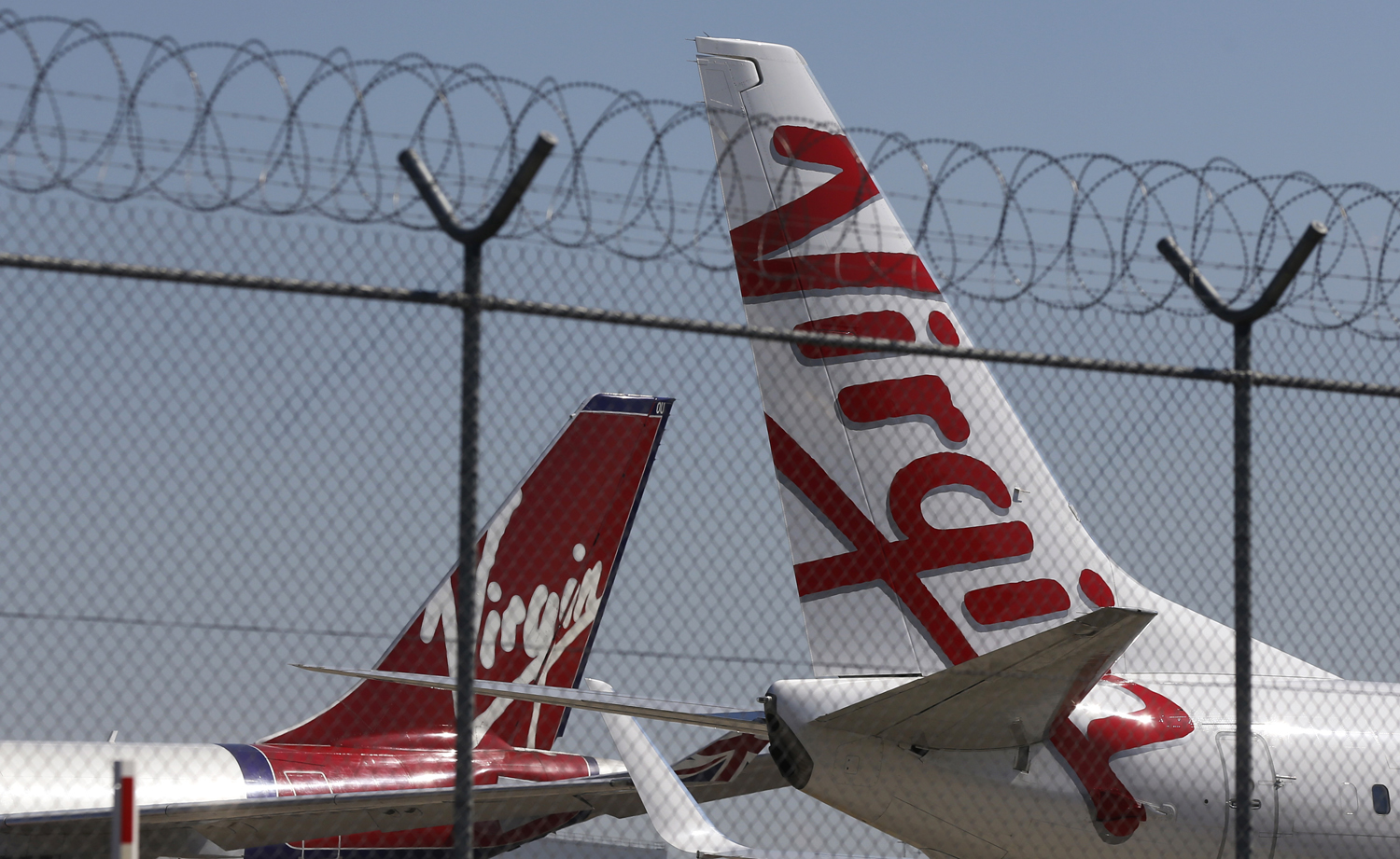 Virgin planes are parked next to each other at Kingsford Smith airport in Sydney