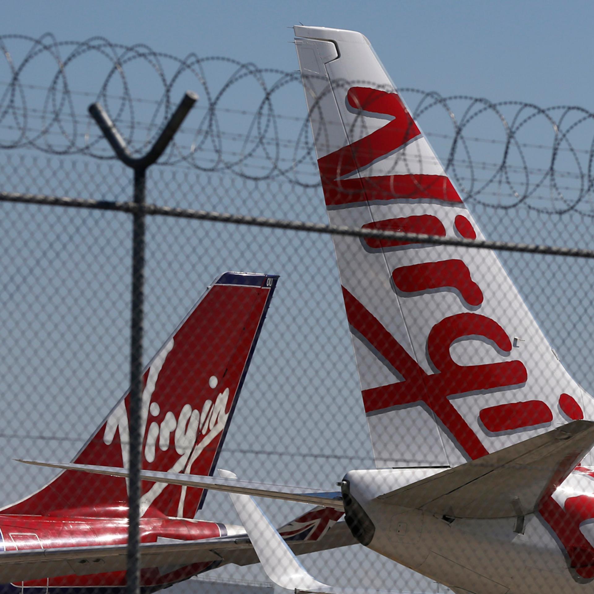 Virgin planes are parked next to each other at Kingsford Smith airport in Sydney