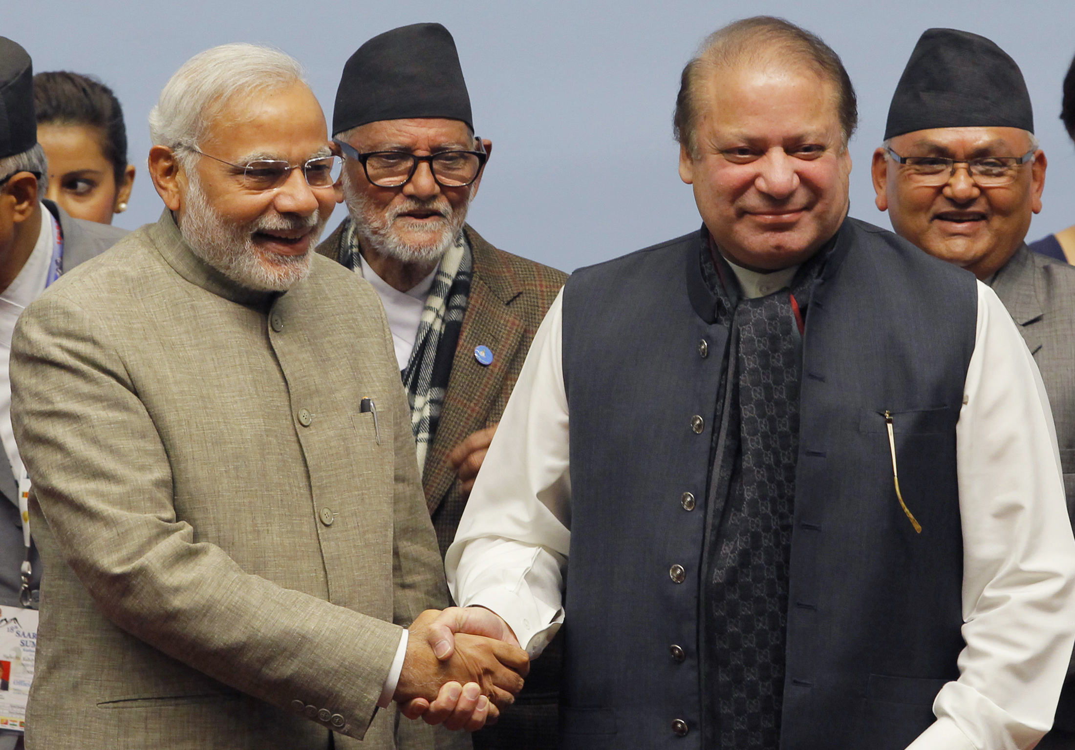 India's PM Modi shakes hands with his Pakistani counterpart Sharif as Nepal's PM Koirala watches during the closing session of 18th SAARC summit in Kathmandu