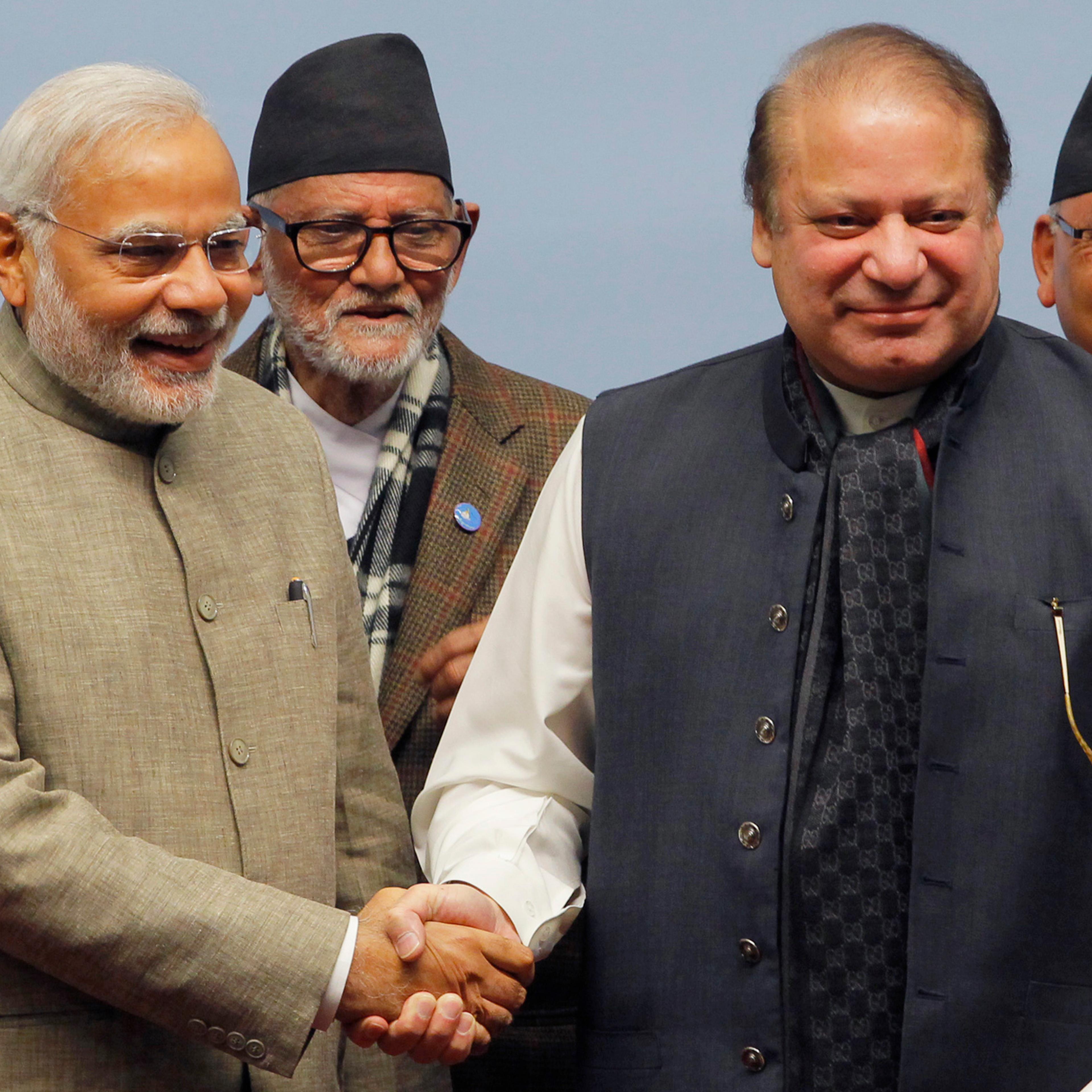 India's PM Modi shakes hands with his Pakistani counterpart Sharif as Nepal's PM Koirala watches during the closing session of 18th SAARC summit in Kathmandu
