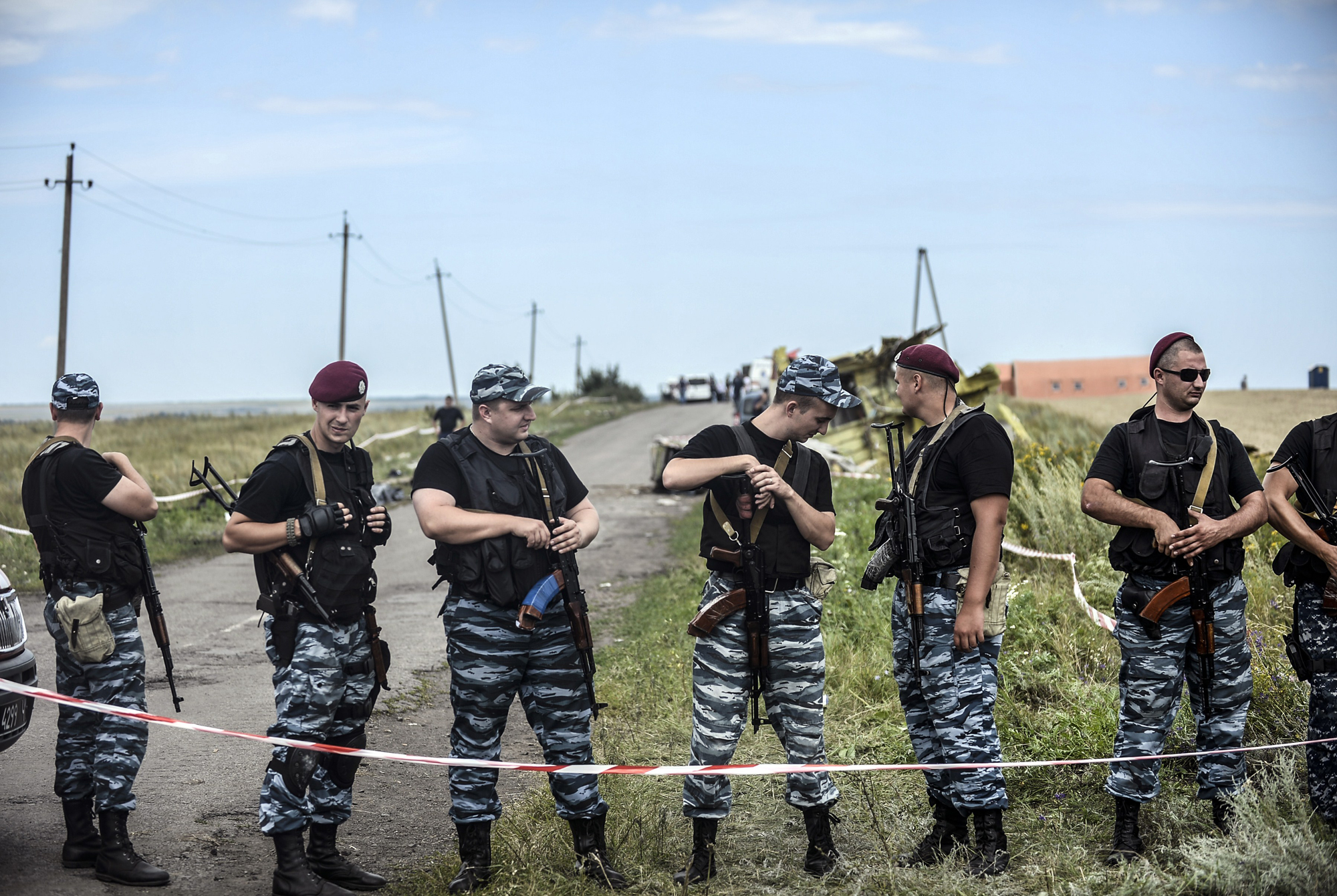 Armed pro-Russian separatists stand guard in front of the crash site of Malaysia Airlines Flight MH17, near the village of Grabove, in the region of Donetsk on July 20, 2014.