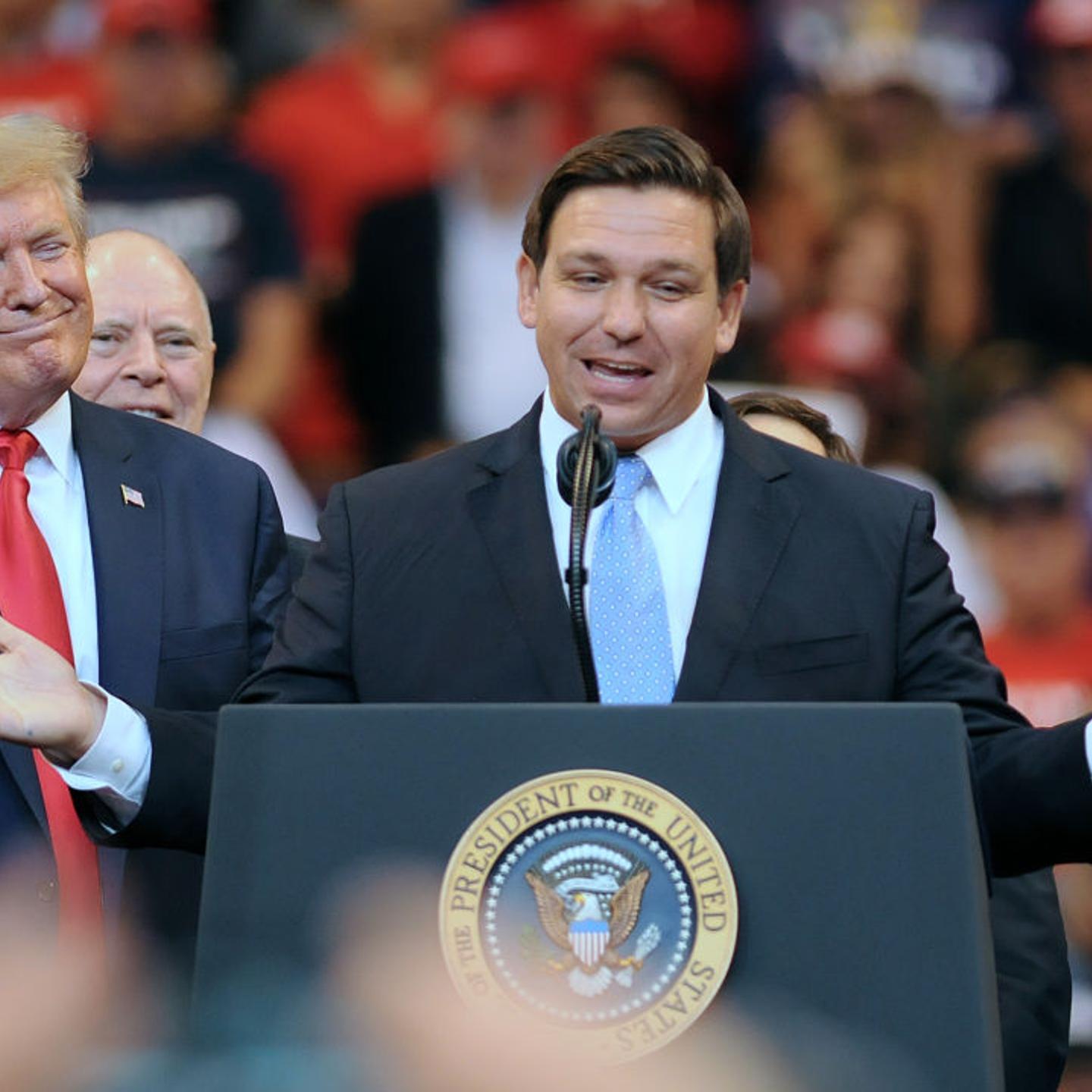 U.S. President Donald Trump looks on as Florida Governor Ron