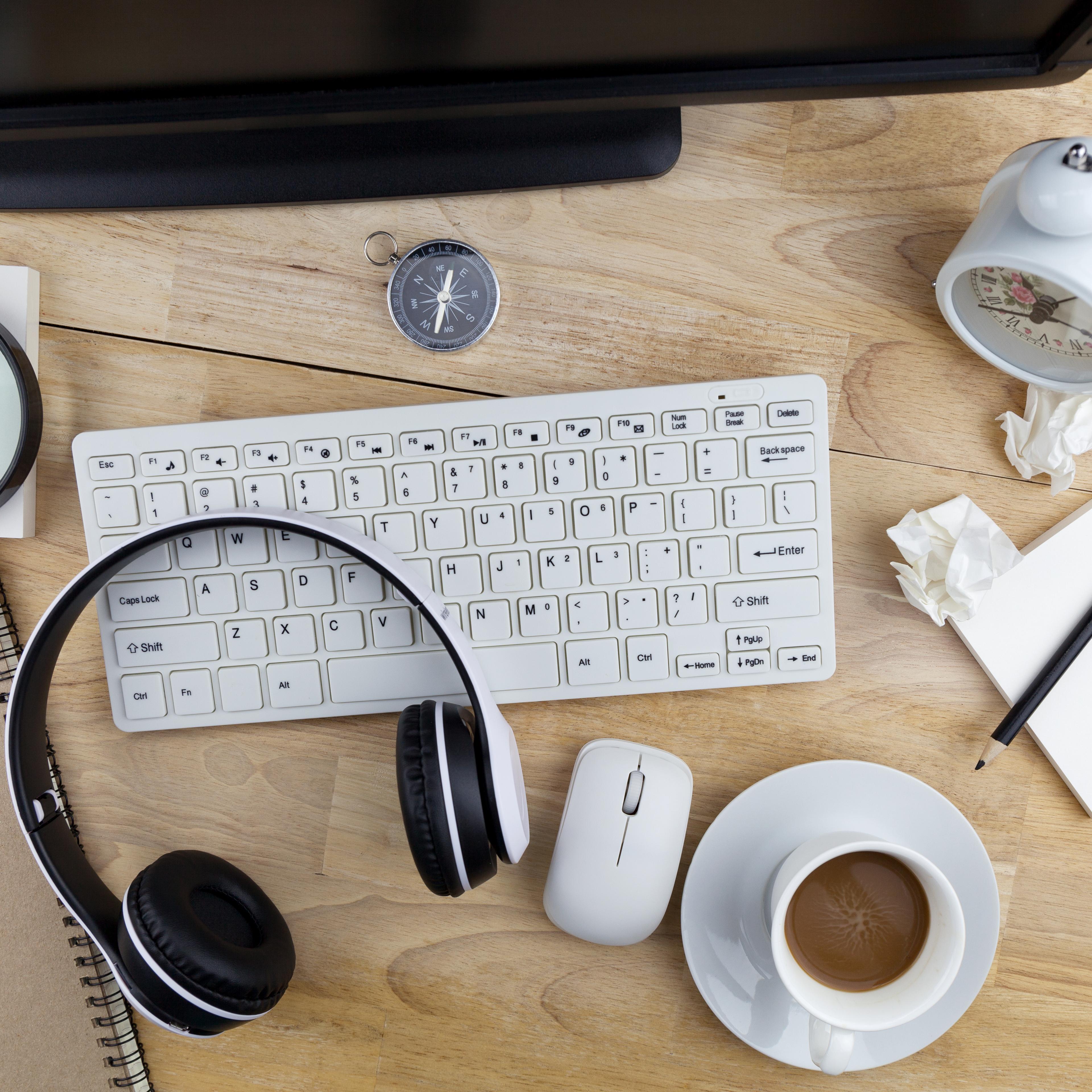 High Angle View Of Computer With Coffee And Clock On Desk