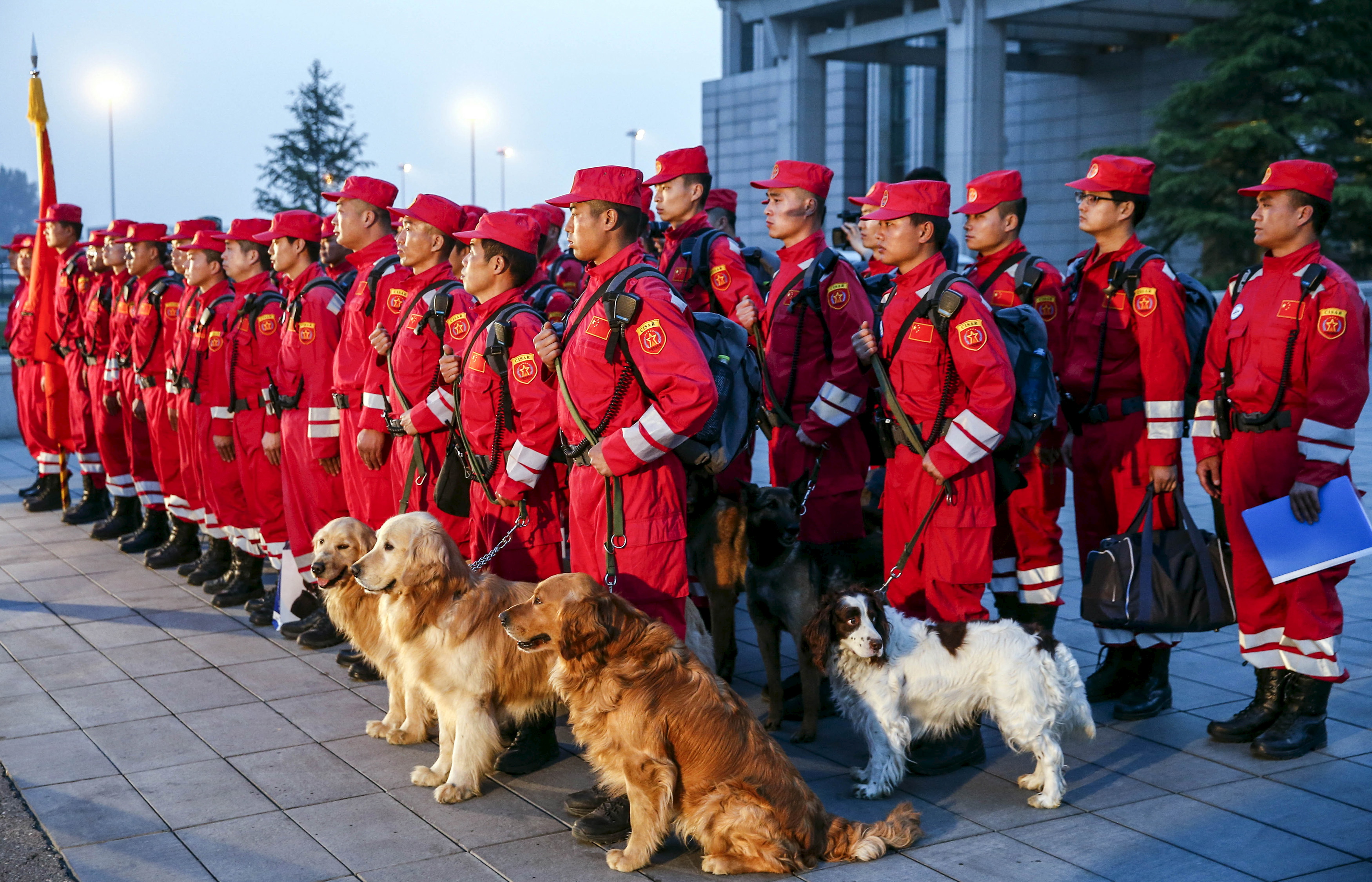 Members of Chinese International Search and Rescue Team and their rescue dogs gather before boarding a charted plane to Kathmandu, after a 7.9 magnitude earthquake hit Nepal, at Beijing Capital International Airport
