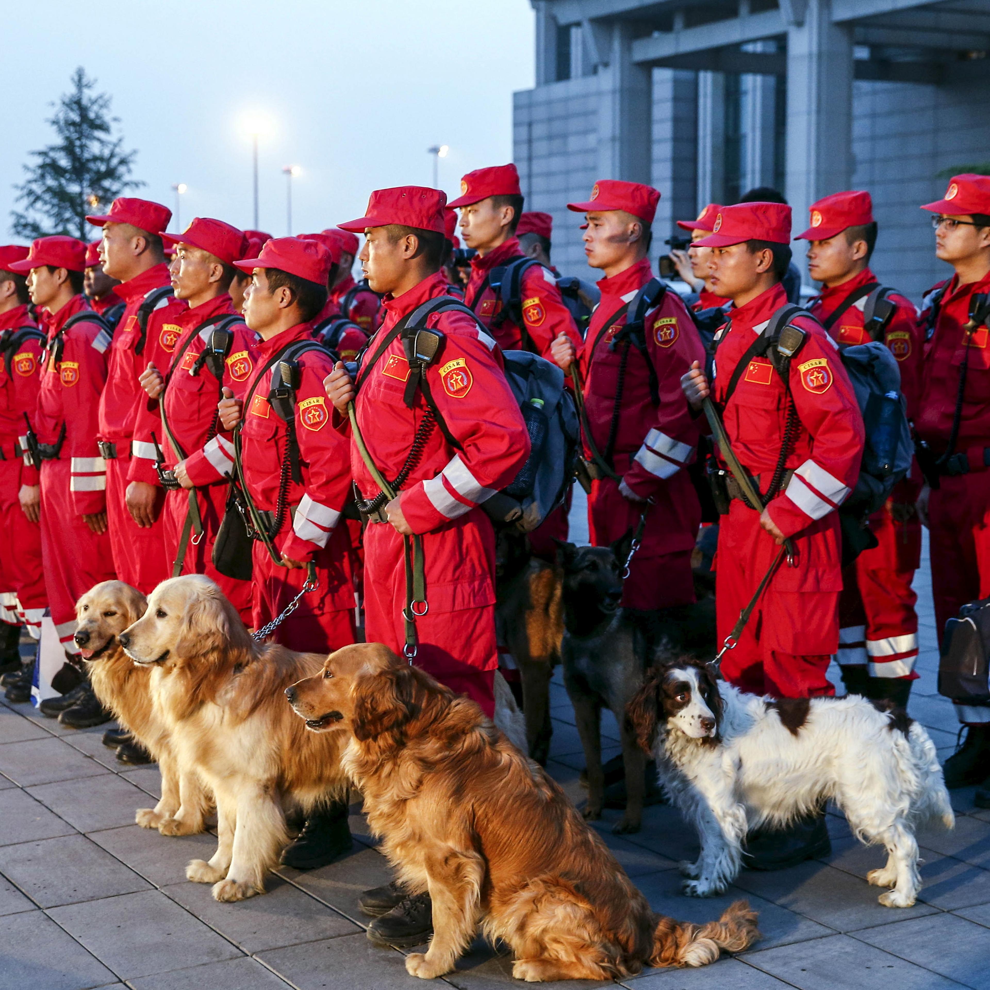 Members of Chinese International Search and Rescue Team and their rescue dogs gather before boarding a charted plane to Kathmandu, after a 7.9 magnitude earthquake hit Nepal, at Beijing Capital International Airport