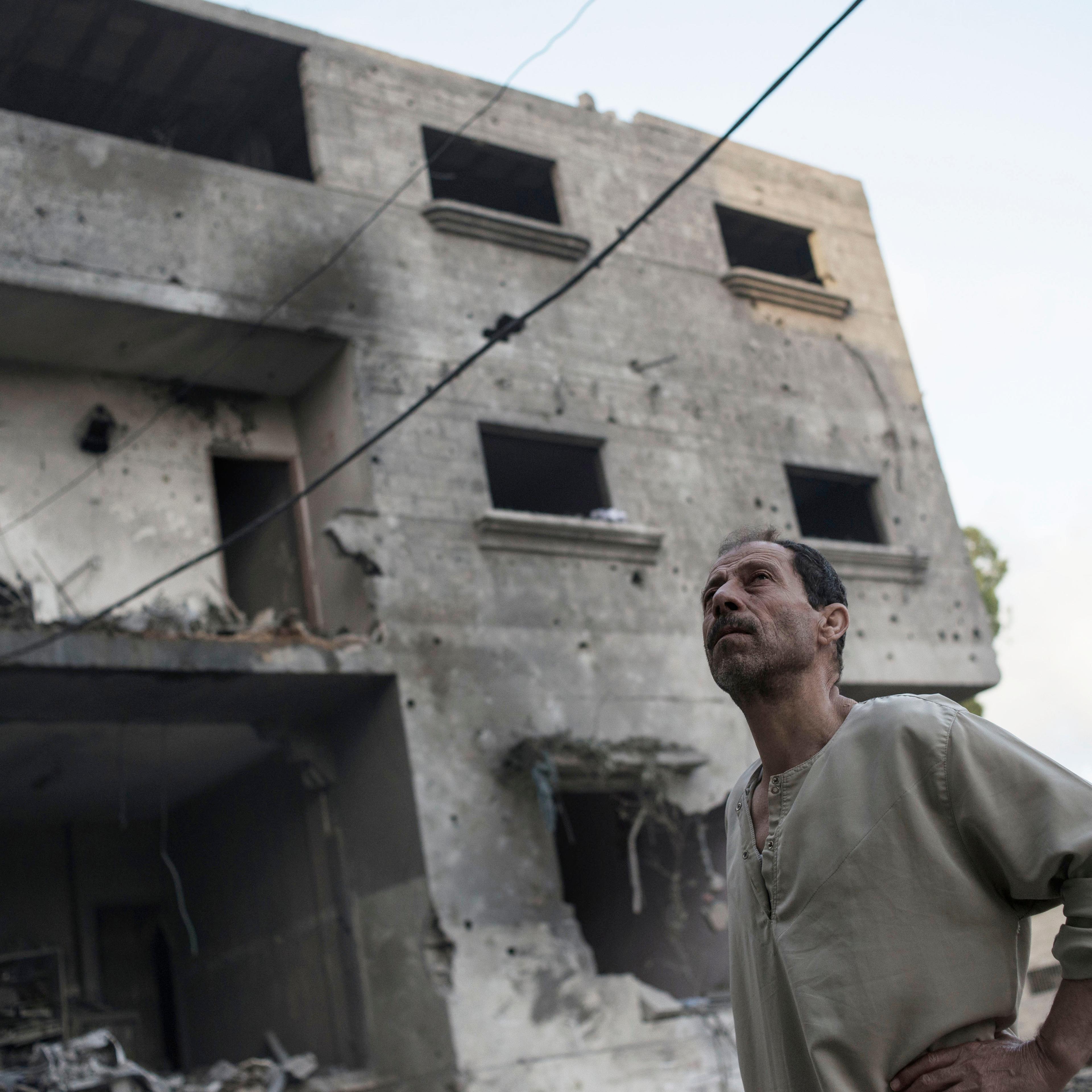Gaza Strip, Gaza City: Palestinian man stands near a damaged building by Israeli airstrike targeting Hamas police chief Tayseer al-Batsh on July 13, 2014 in Gaza City. ALESSIO ROMENZI
