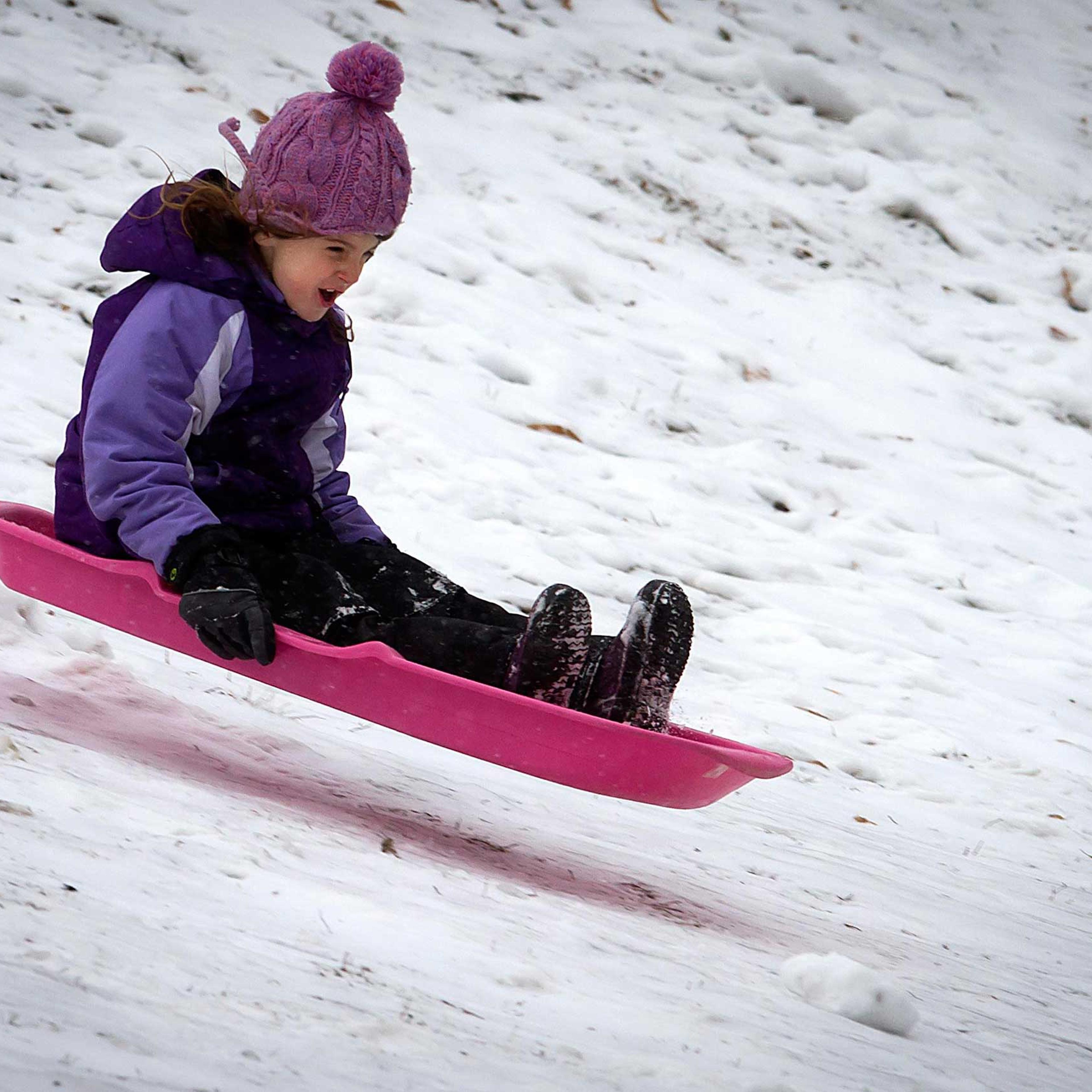 Children play in Central Park as it snows in the Manhattan borough of New York