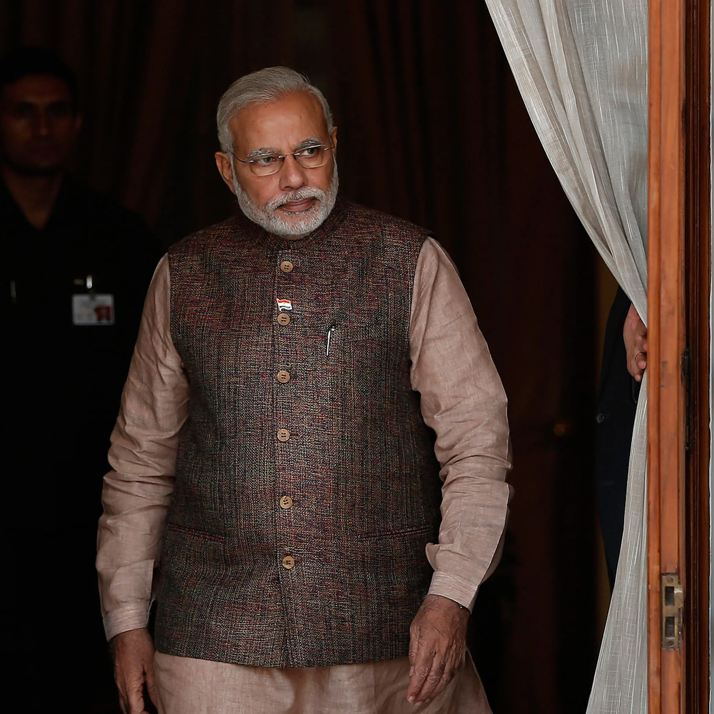India's Prime Minister Narendra Modi comes out of a meeting room to receive his Bhutanese counterpart Tshering Tobgay before the start a bilateral meeting in New Delhi on May 27, 2014