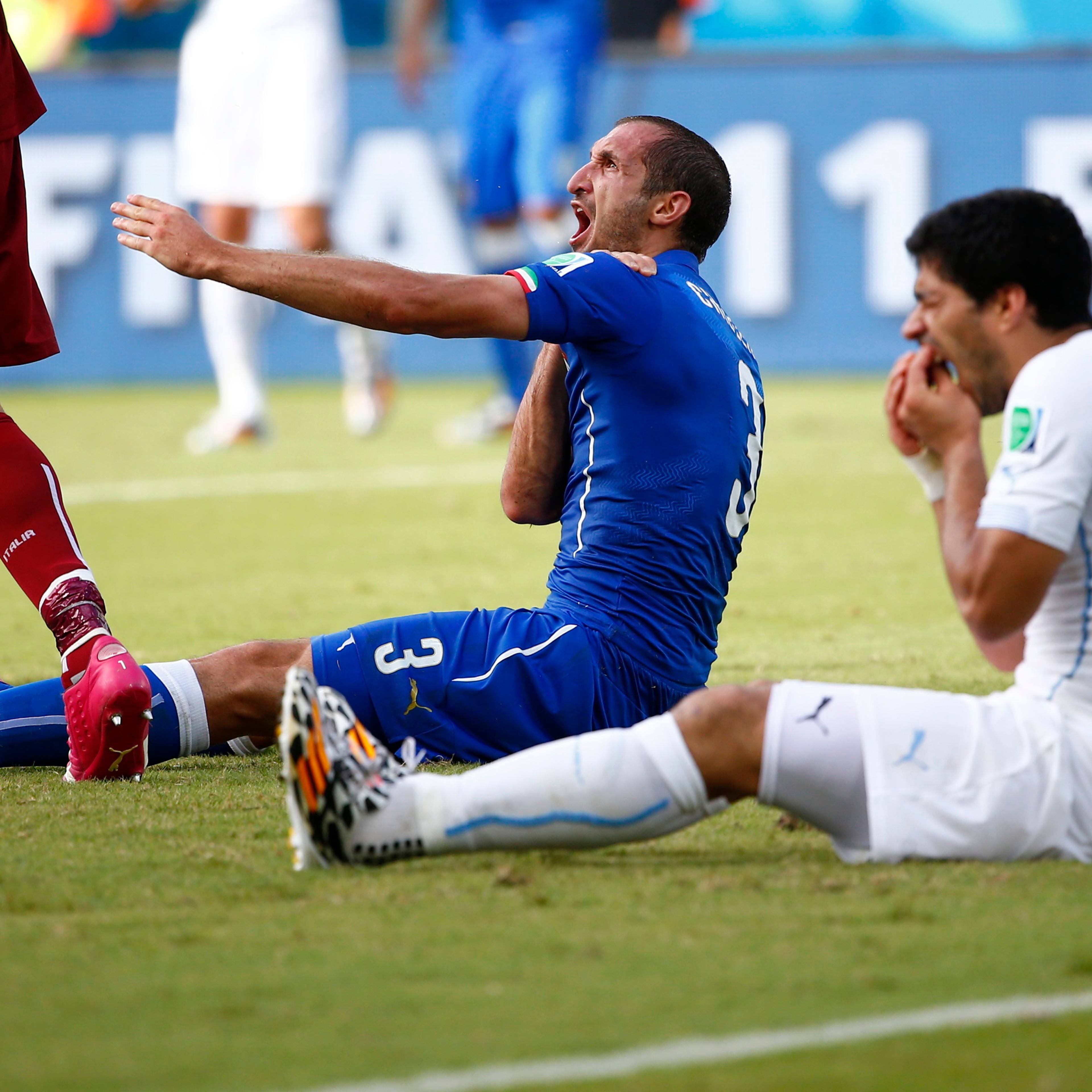 Uruguay's Luis Suarez reacts after clashing with Italy's Giorgio Chiellini during their 2014 World Cup Group D soccer match at the Dunas arena in Natal