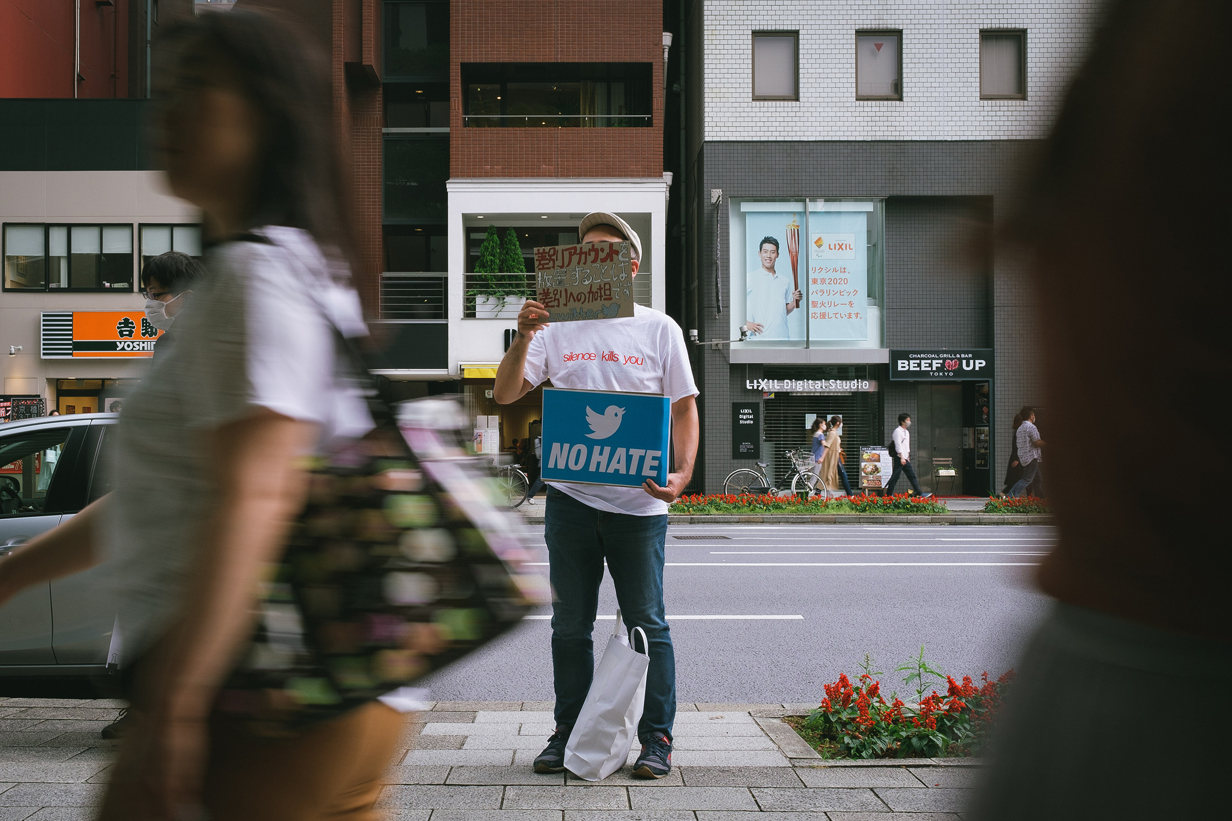 People gather in front of Twitter Japan headquarters in Tokyo to pressure the company to be more active against hate speech and discrimination on the platform, June 6, 2020.