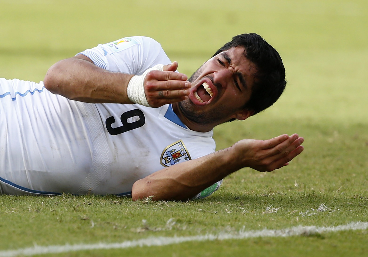 Uruguay's Luis Suarez reacts after clashing with Italy's Giorgio Chiellini during their 2014 World Cup Group D soccer match at the Dunas arena in Natal
