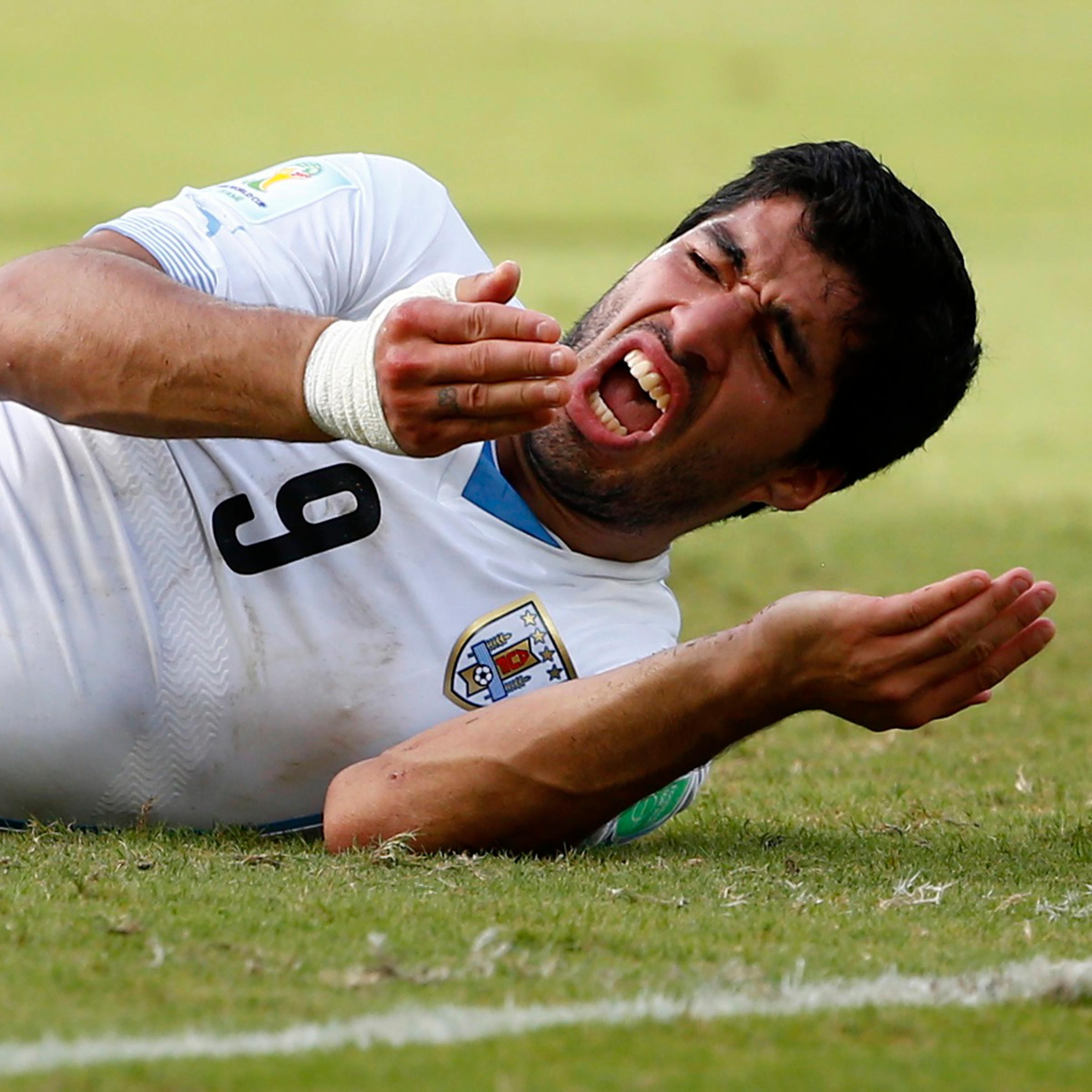 Uruguay's Luis Suarez reacts after clashing with Italy's Giorgio Chiellini during their 2014 World Cup Group D soccer match at the Dunas arena in Natal