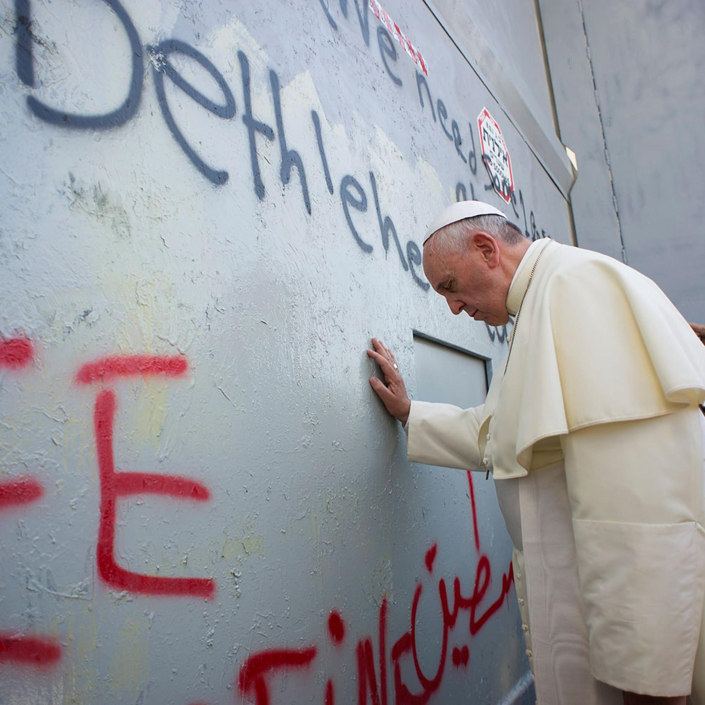 Pope Francis touches the wall that divides Israel from the West Bank in the West Bank city of Bethlehem