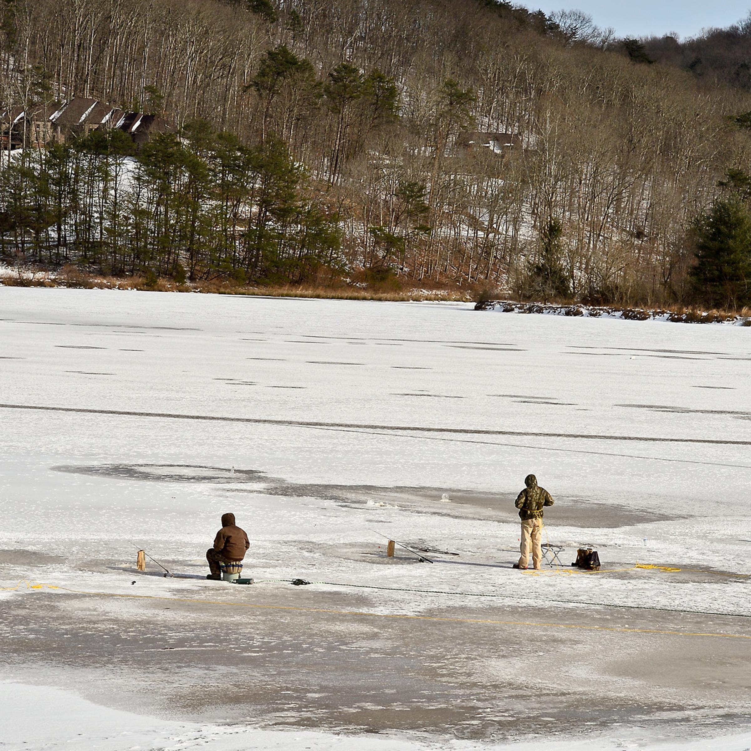 A group of ice fishers gather on the frozen surface of Ridenour Lake in Nitro, W.Va., Jan. 27, 2014.
