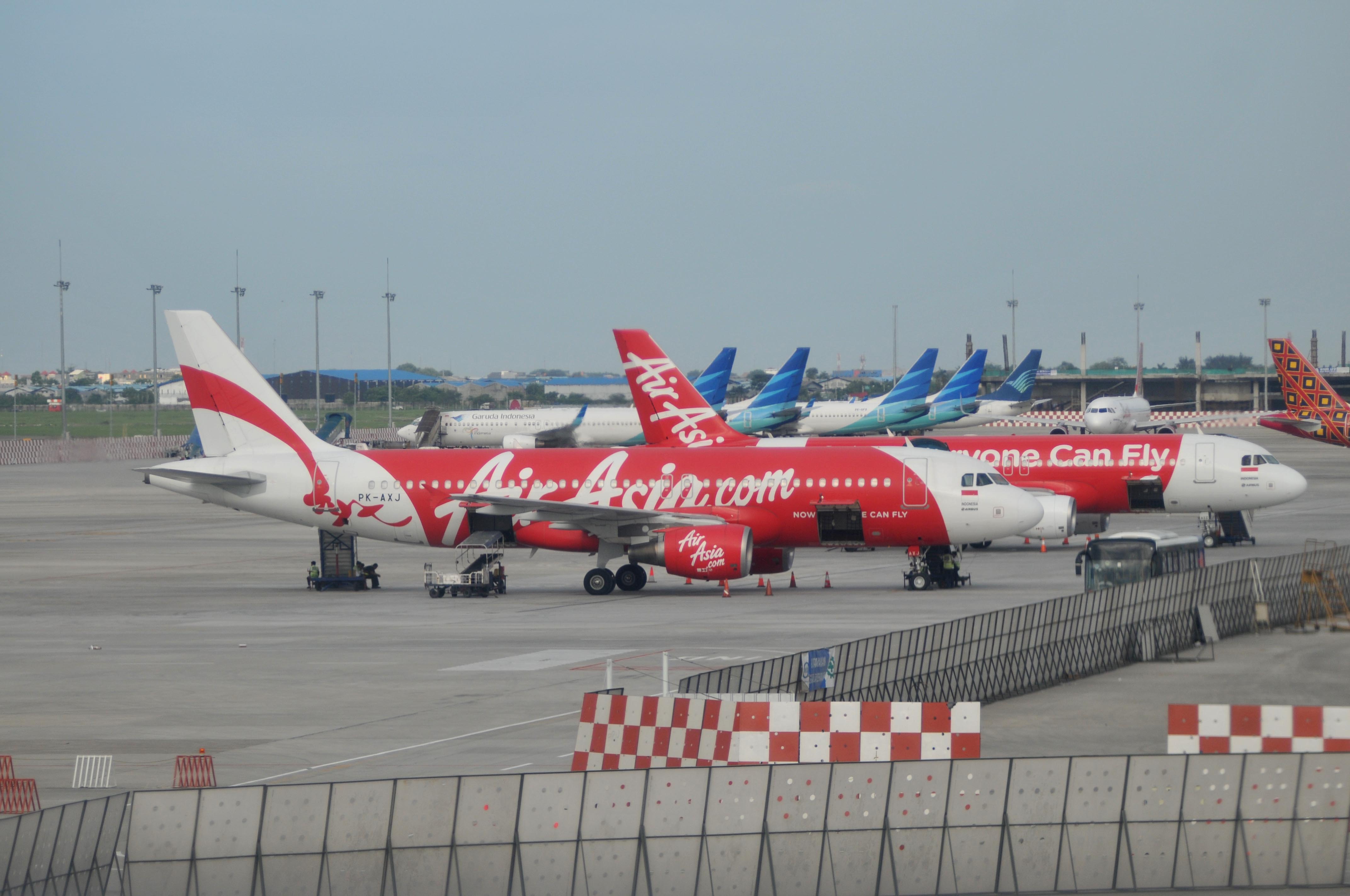 JAKARTA, INDONESIA - DECEMBER 29 : AirAsia aircrafts on the strip at Soekarno Hatta International Airport near Jakarta, on December 29, 2014. Malaysia, Singapore and Australia  have deployed planes and ships to assist in the Indonesian search for the mis