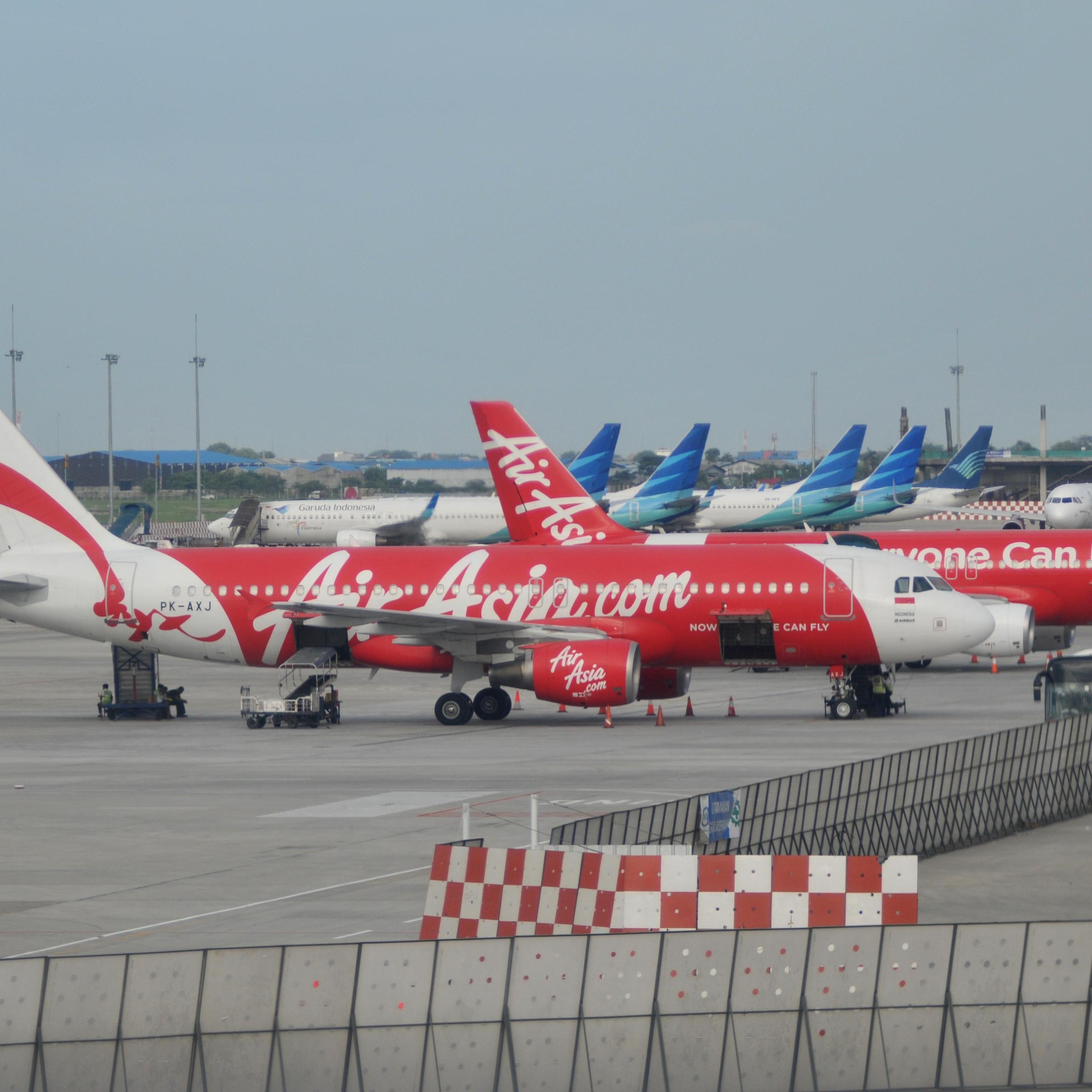 JAKARTA, INDONESIA - DECEMBER 29 : AirAsia aircrafts on the strip at Soekarno Hatta International Airport near Jakarta, on December 29, 2014. Malaysia, Singapore and Australia have deployed planes and ships to assist in the Indonesian search for the mis