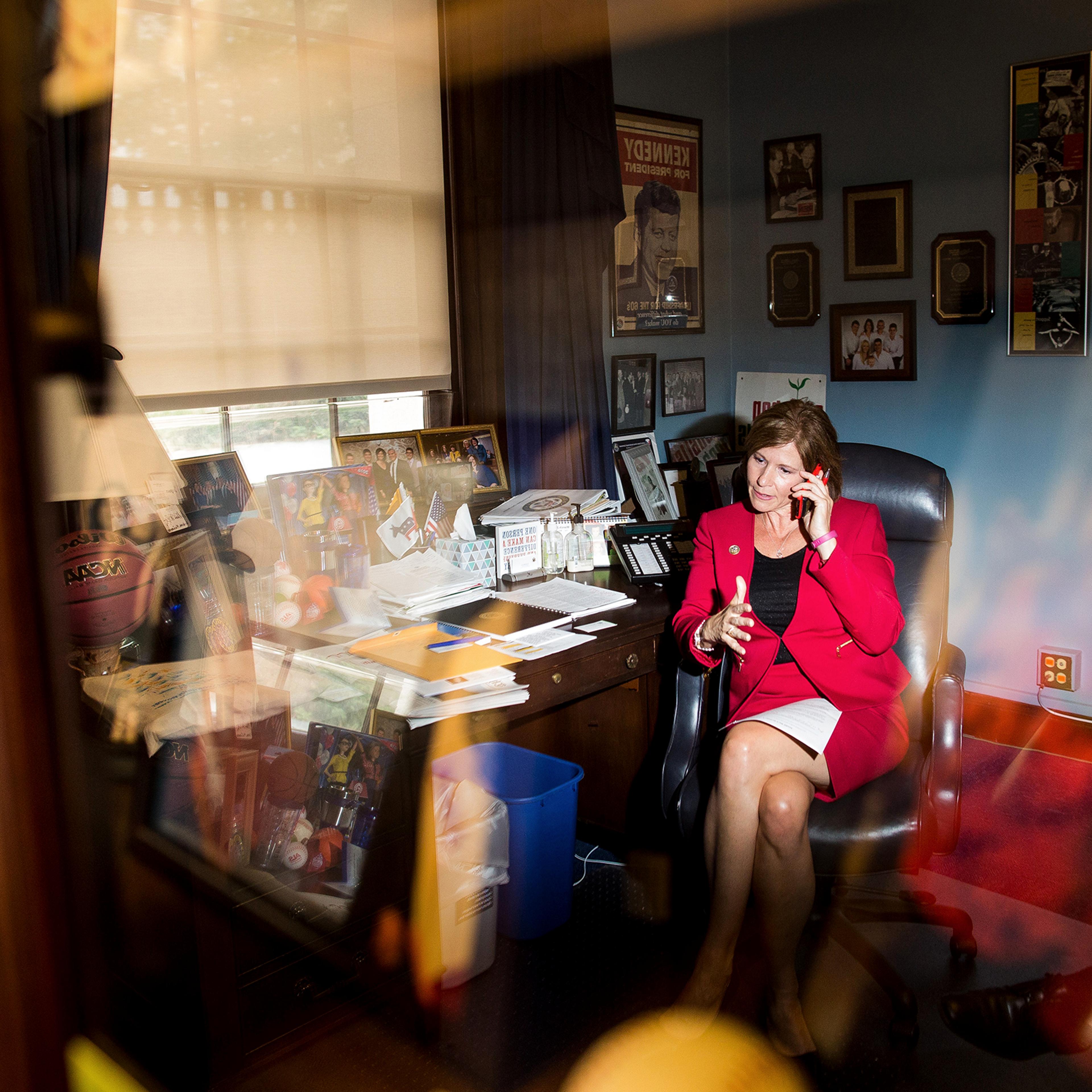 Bustos works the phone at her office on Capitol Hill in May 2017