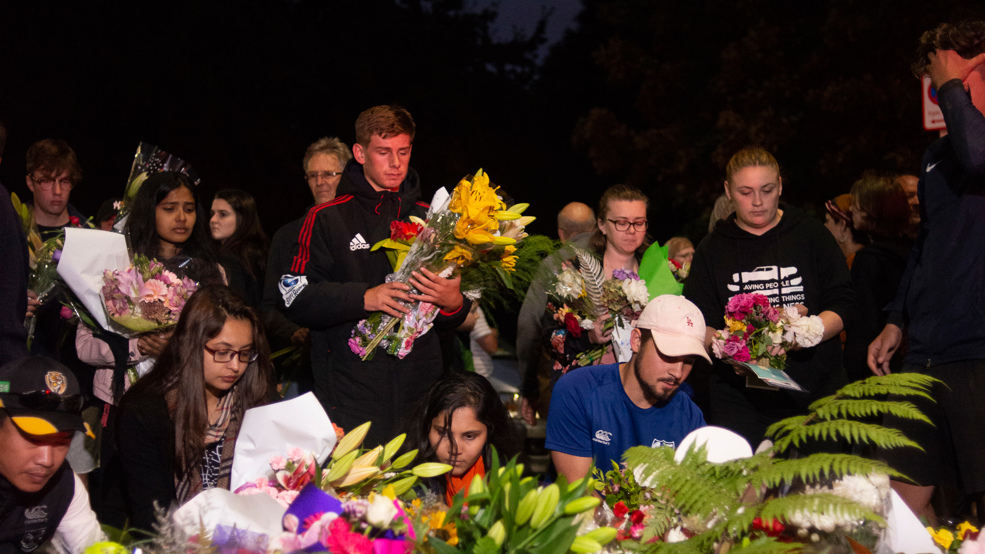 Mourners gather to lay flowers and messages at a vigil for the victims of the terrorist attack in Christchurch, New Zealand.