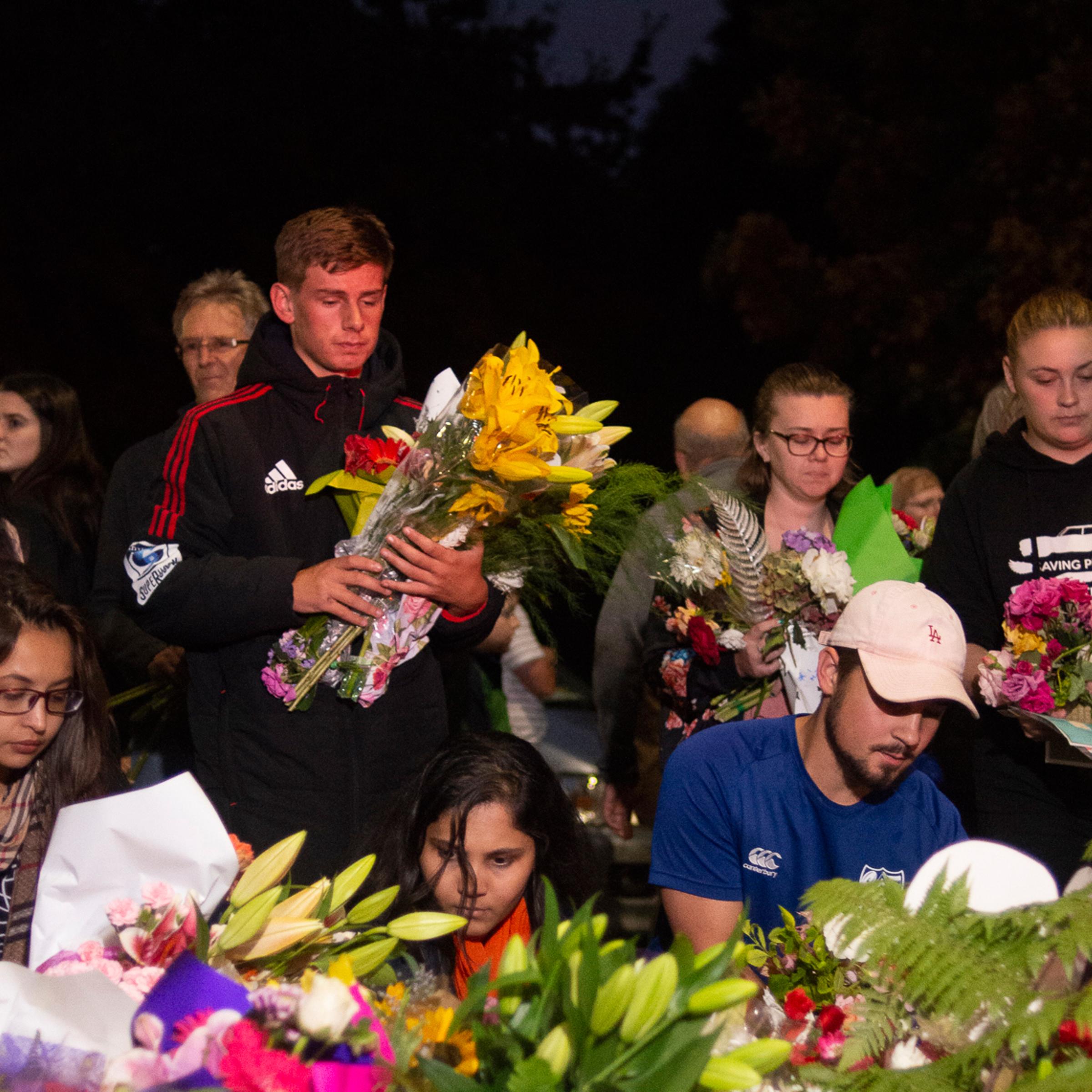 Mourners gather to lay flowers and messages at a vigil for the victims of the terrorist attack in Christchurch, New Zealand.