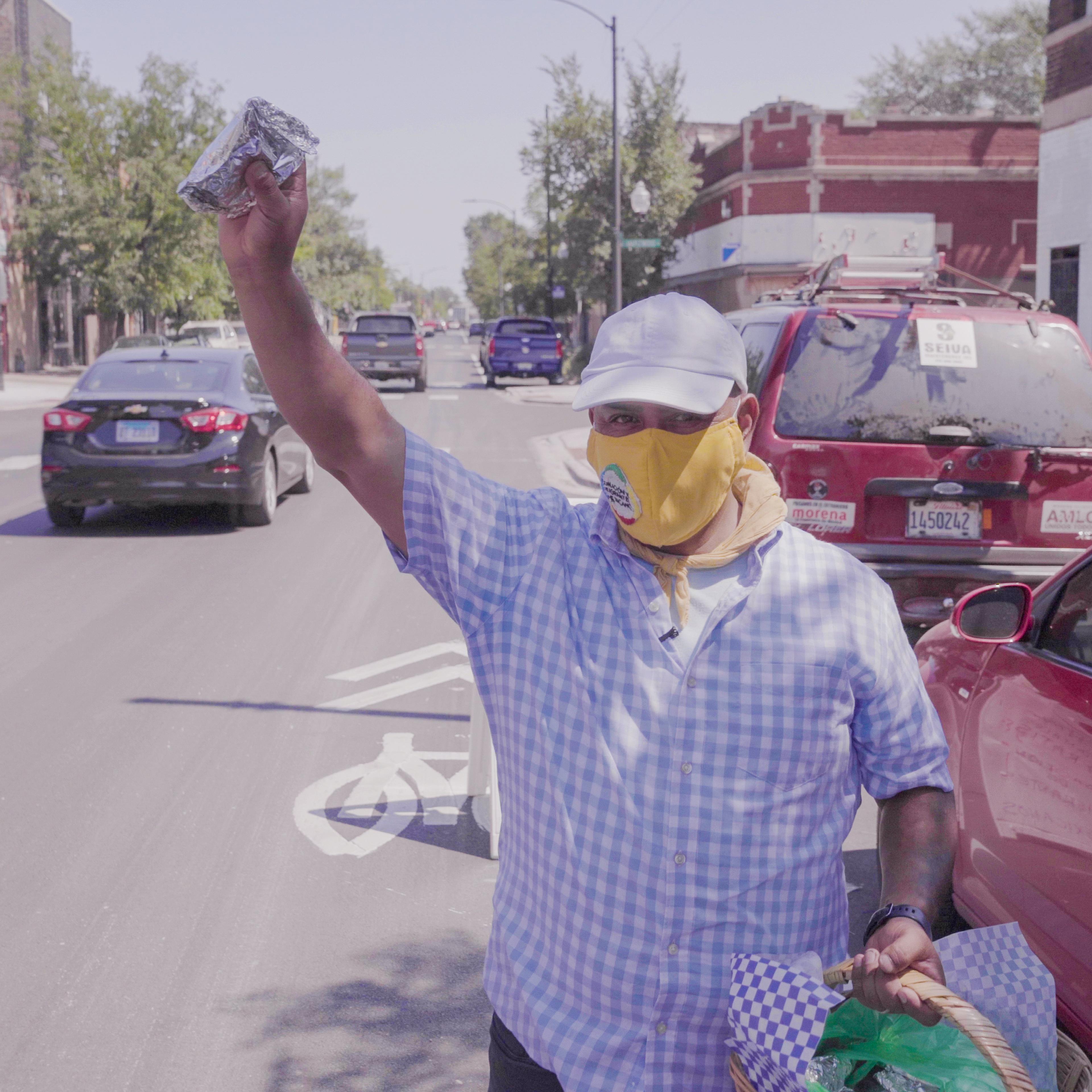 Alfonso Seiva, the president of the Coalition of Mexican Immigrants, hands out food in South Chicago in an episode of PBS/ Latino Public Broadcasting's "Latinos Are Essential."