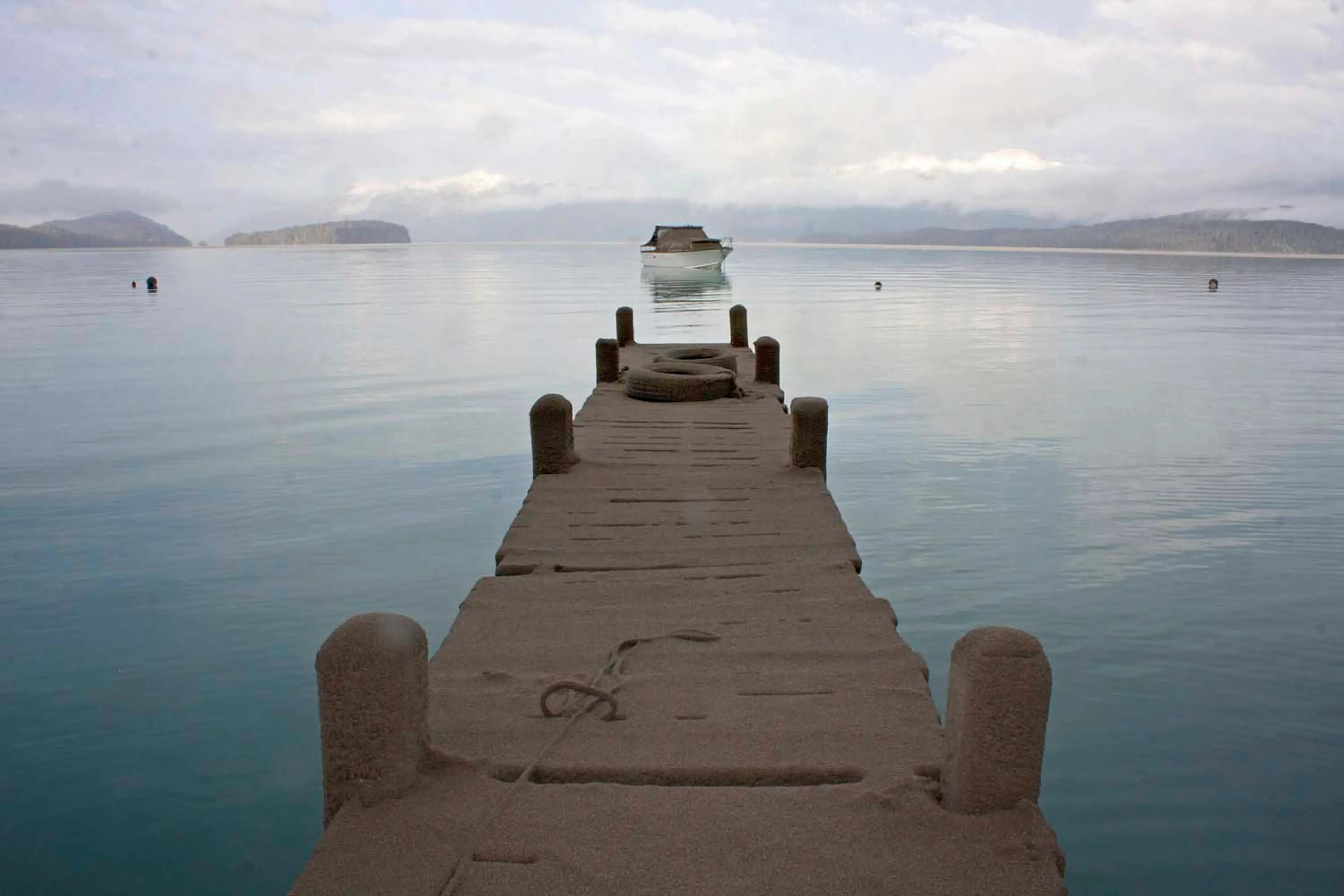 The pier of Puerto Arauco at Nahuel Huapi Lake is seen covered by sand and volcanic ash from the Chilean Puyehue-Cordon Caulle volcano in Villa La Angostura, southern Argentina, Friday, June 17, 2011. The volcano started erupting on June 4 after remaining dormant for decades.