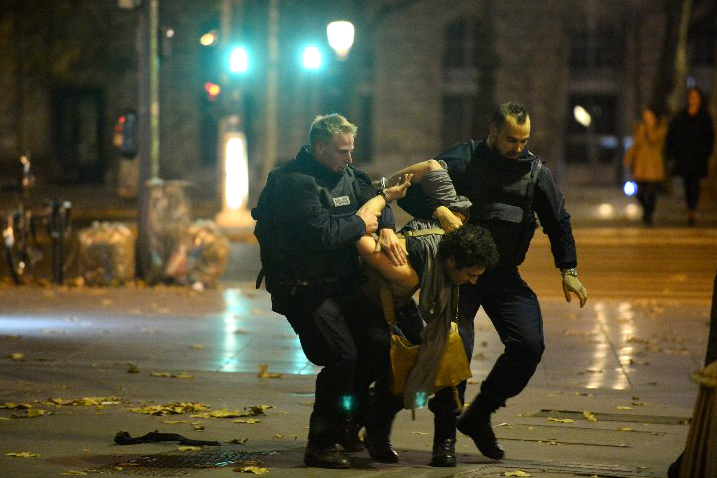 A suspect is apprehended near Place Republique on Nov. 13, 2015, in Paris.