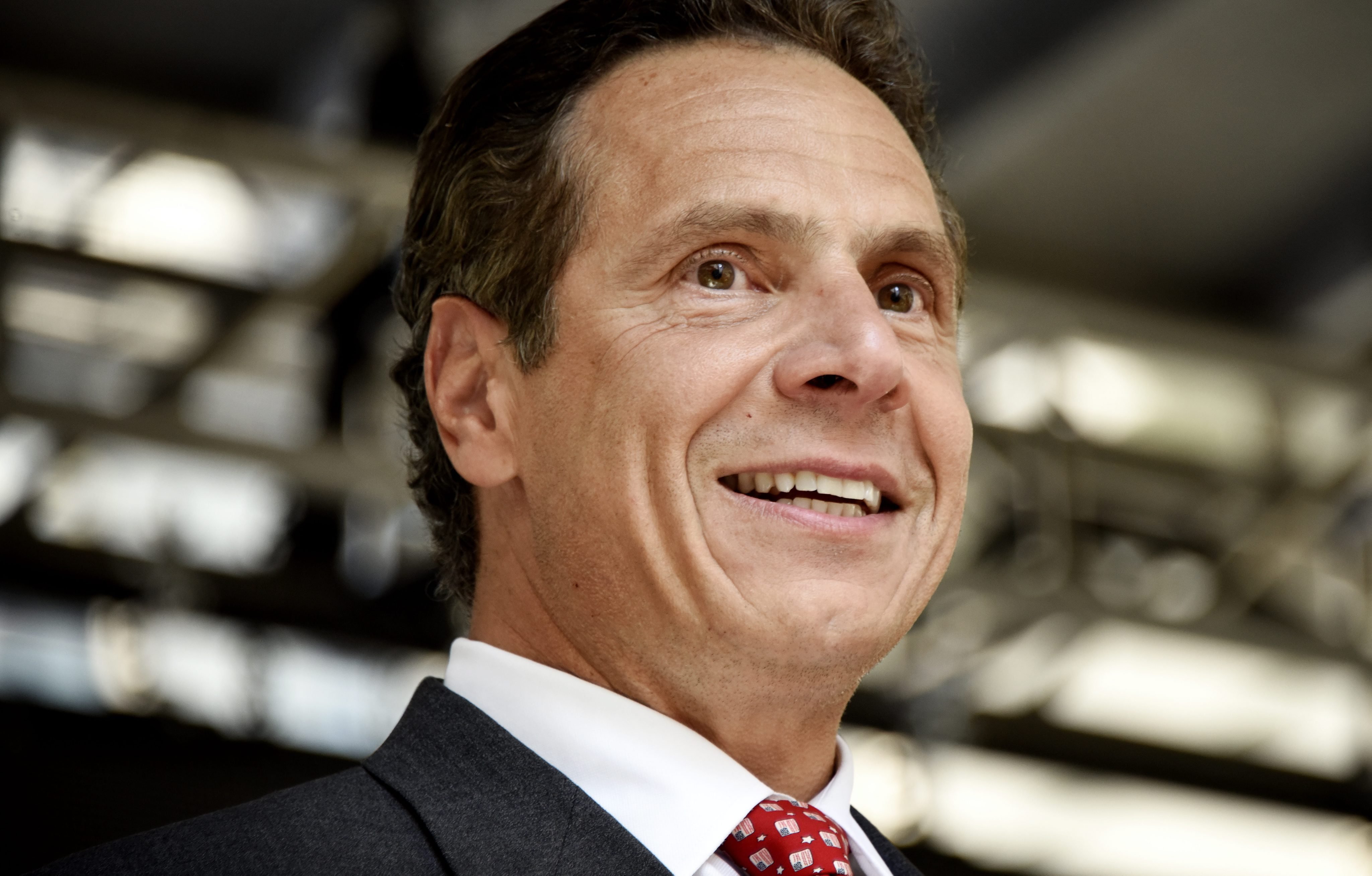 New York Governor Andrew Cuomo smiles while on stage at a rally following a New York state wage board meeting where a panel announced their recommendation that the minimum wage in New York be raised, in stages, to $15 per hour, in New York on July 22, 20