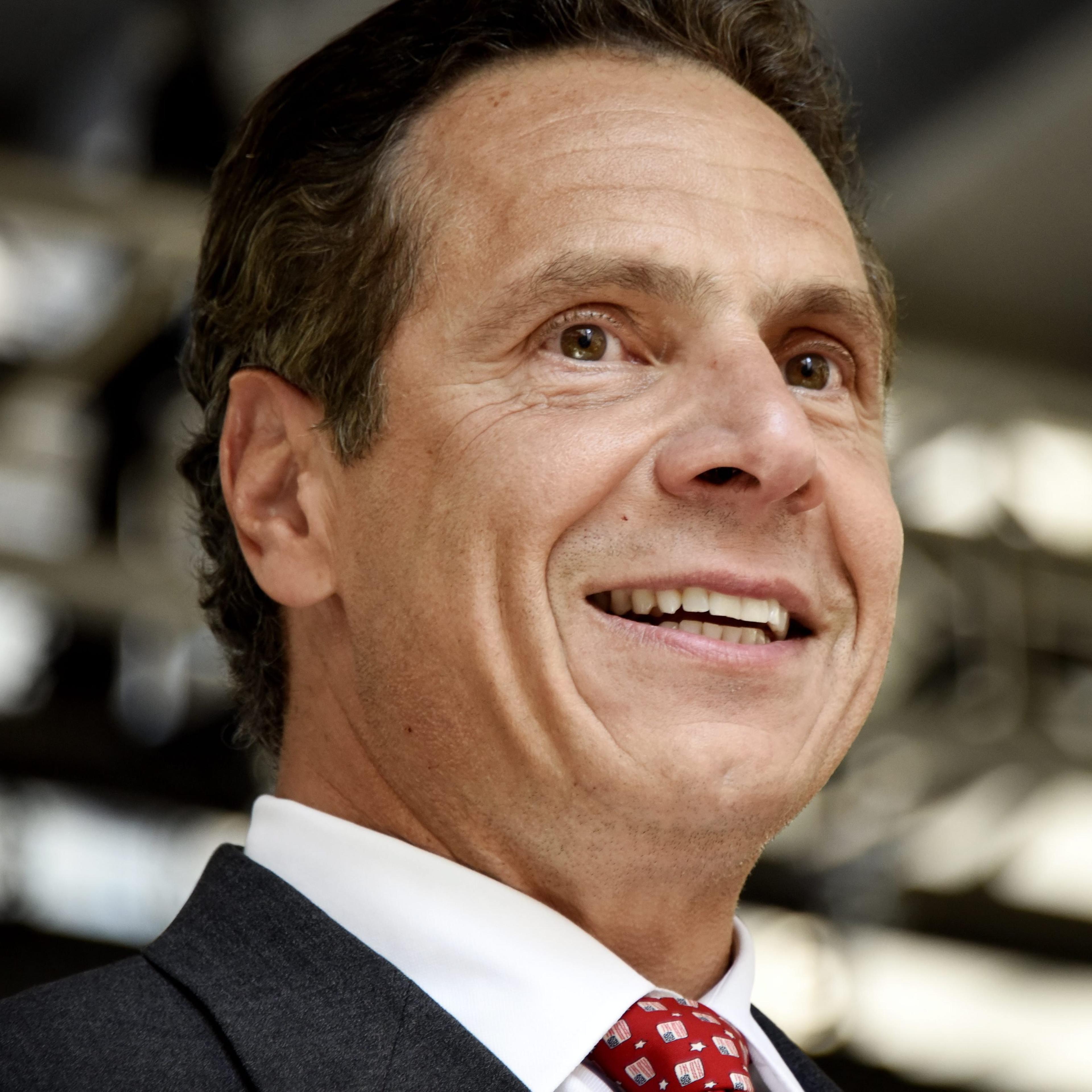 New York Governor Andrew Cuomo smiles while on stage at a rally following a New York state wage board meeting where a panel announced their recommendation that the minimum wage in New York be raised, in stages, to $15 per hour, in New York on July 22, 20