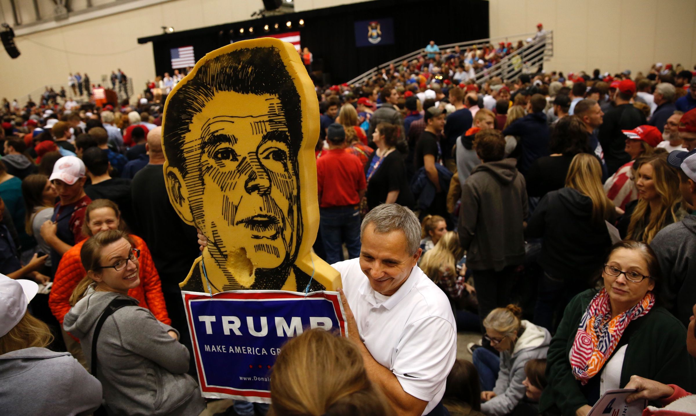 A man holds a Ronald Reagan-Donald Trump sign