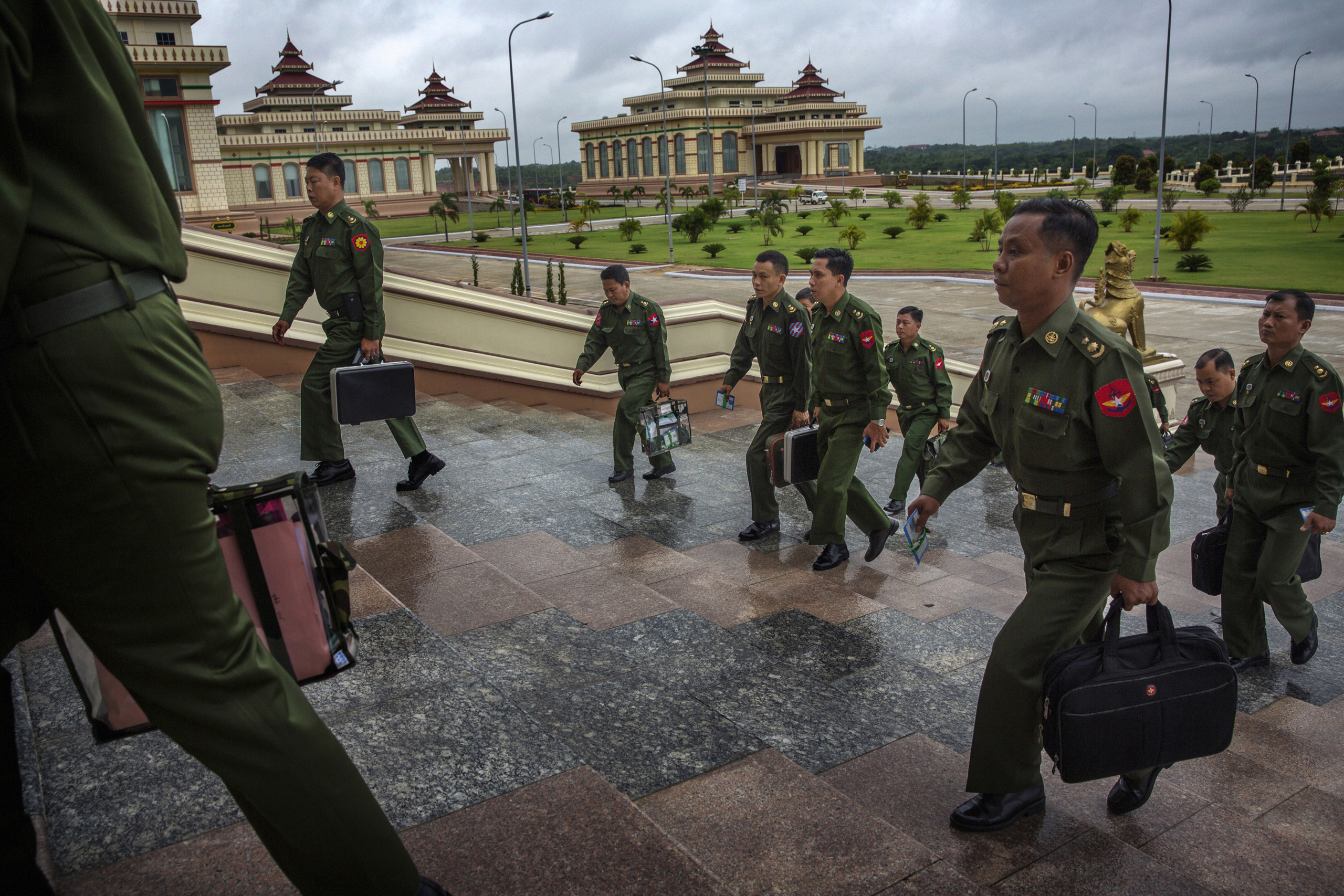 MPs representing the military arrive for a parliamentary session in the Naypyidaw, Burma,  June 20th, 2014.