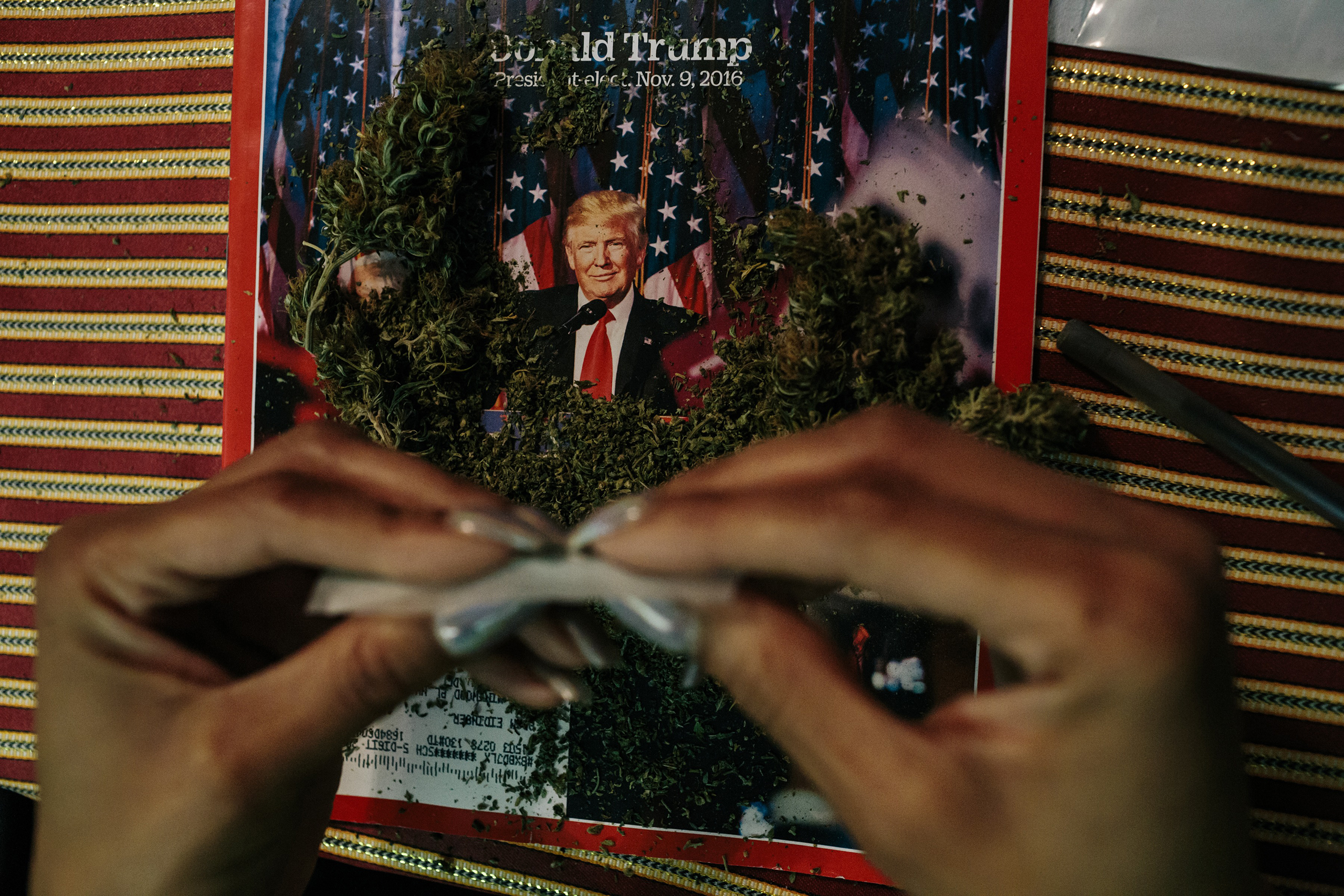 An activist from the cannabis community DCMJ rolls a joint in a Washington, D.C., home on Jan. 16 in preparation for President-Elect Donald Trump’s inauguration. A cofounder of the group said TIME magazines were used after learning a photographer on assi
