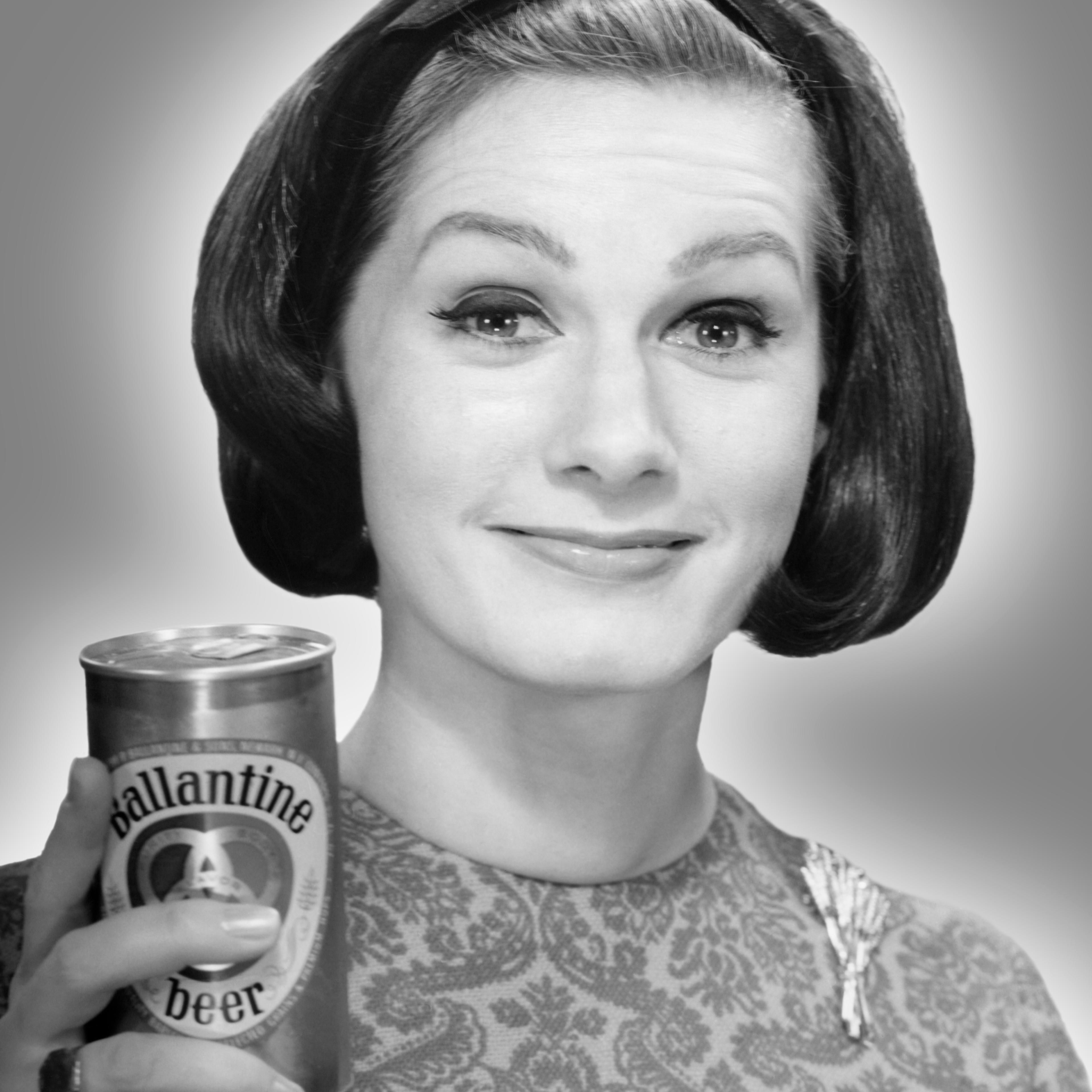 Woman holding can of beer