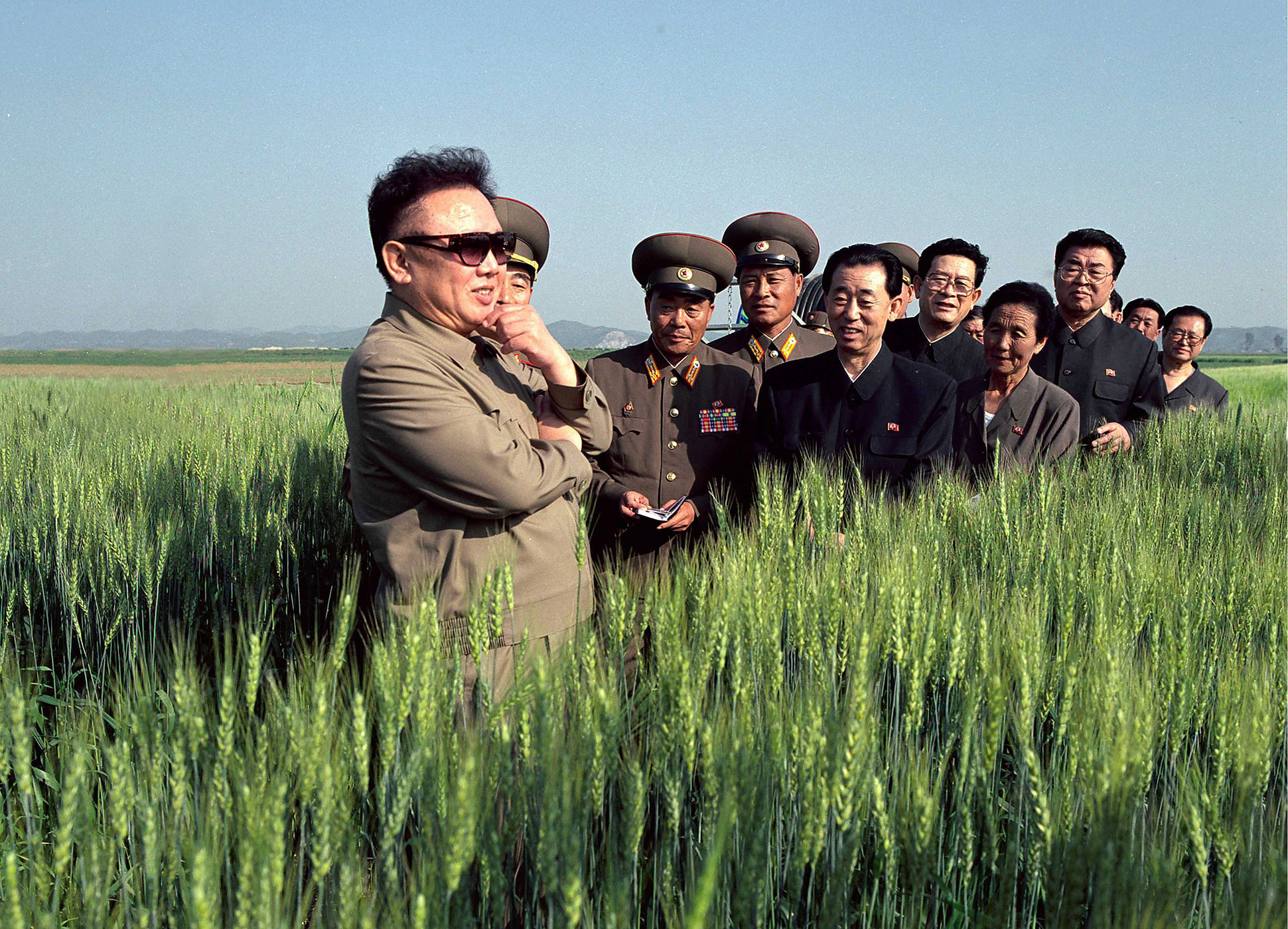 A propaganda picture of North Korea's reclusive leader Kim Jong-Il posed in a field of grain with a group of cadres in Pyongyang, Nov. 17, 2004.