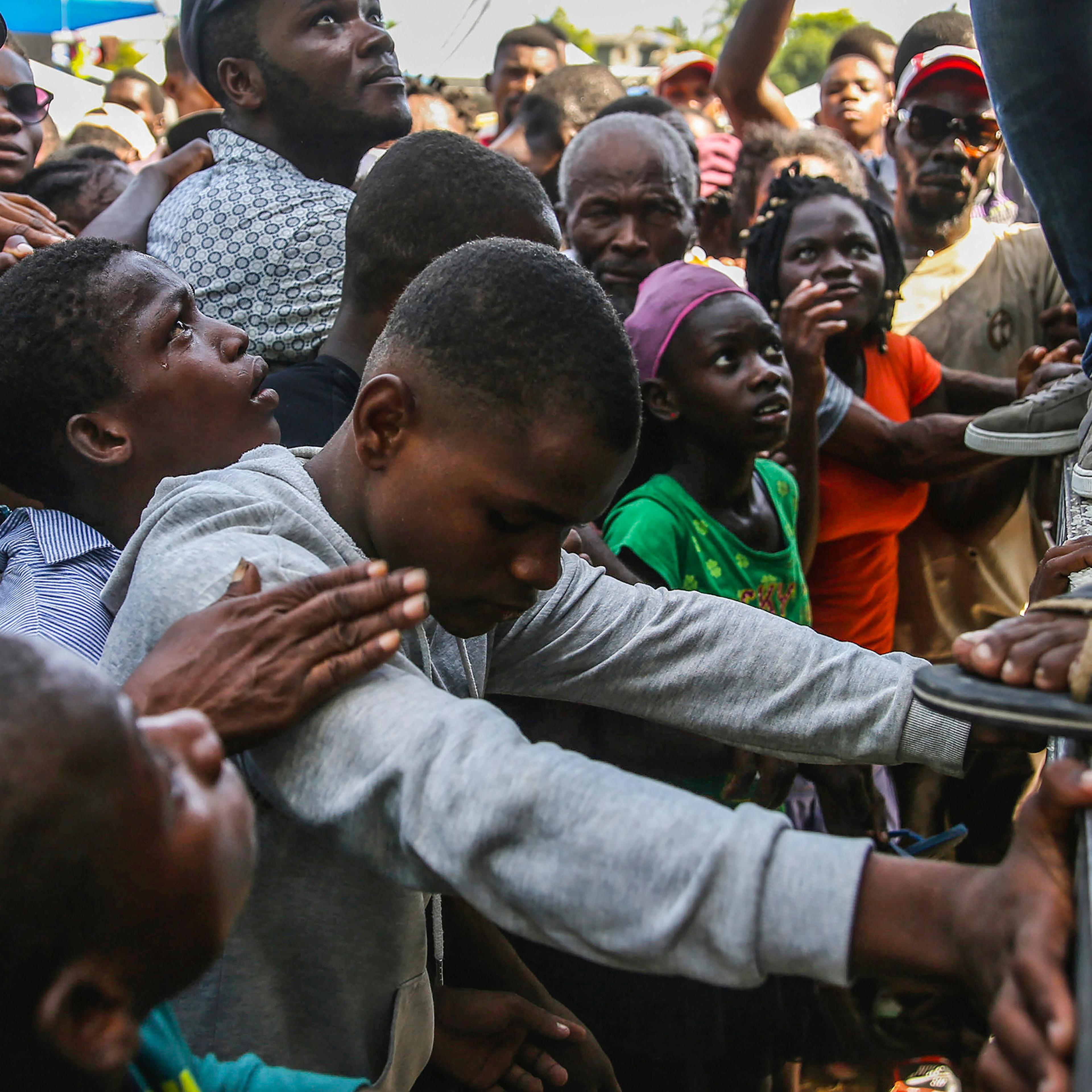 Residents wait for food distribution two days after a 7.2-magnitude earthquake hit, in Les Cayes, Haiti, Aug. 16, 2021.