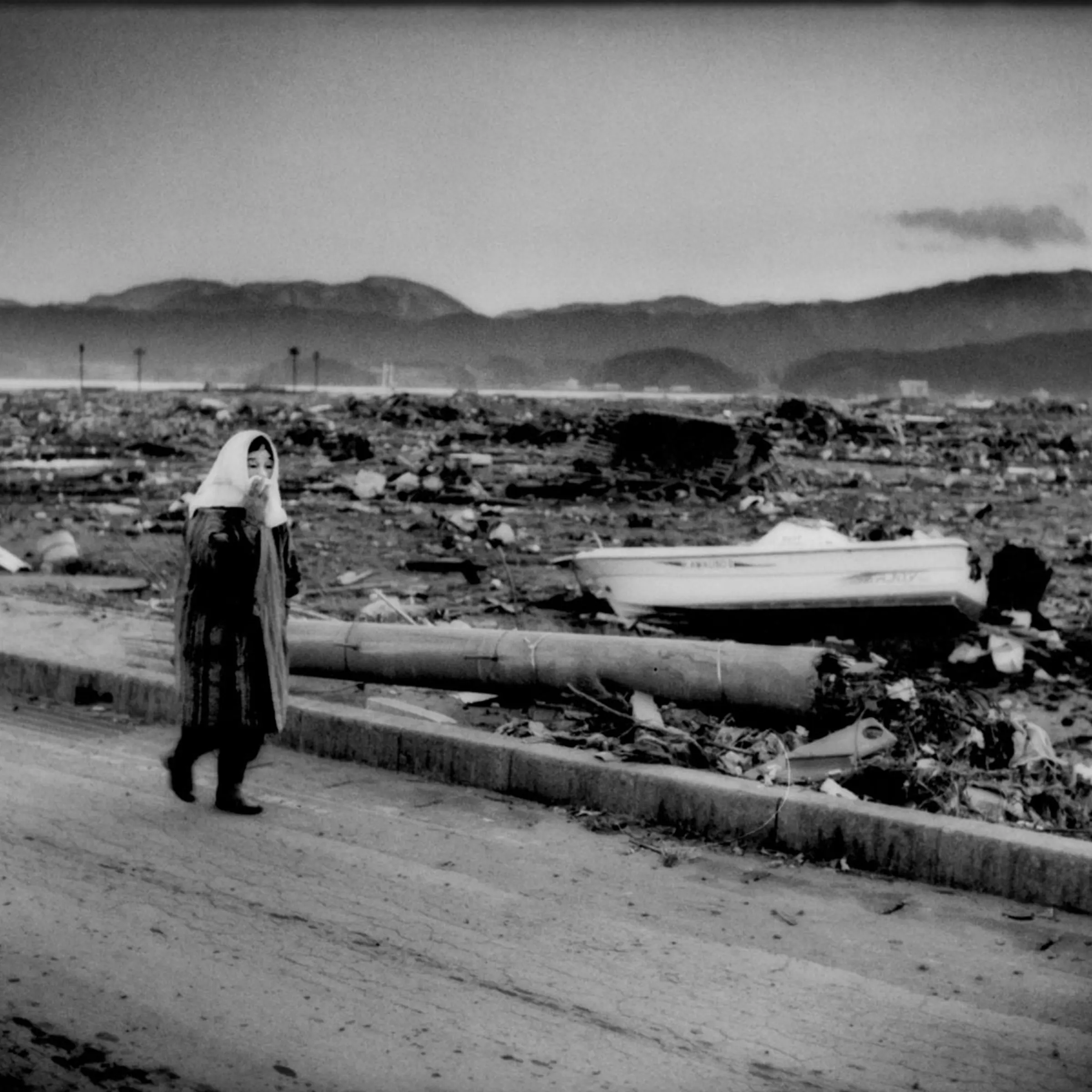An elderly woman shuffles through the destroyed city of Rikuzen-Takata, Iwate Prefecture, Japan. In Rikuzen-Takata, 10,547 residents, nearly half the population of roughly 26,000 people, are living in evacuation shelters. Japan Self Defence Forces say they have found 300 to 400 bodies there. About 5,000 of the city's houses were submerged by the quake-triggered tsunami.